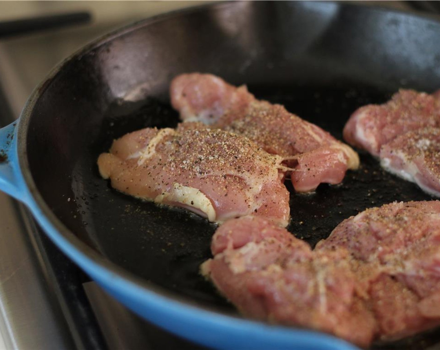 step 8 Heat a heavy-bottomed skillet over medium with Canola Oil (1 Tbsp). Working in batches and being careful not to overcrowd the skillet, place the chicken seasoned side down and cook for 5-7 minutes.