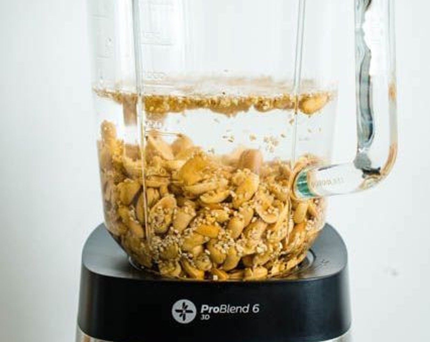 step 1 Pour Dry Roasted Peanuts (1 1/2 cups), Toasted White Sesame Seeds (2 Tbsp), and Water (3 cups) into a blender.