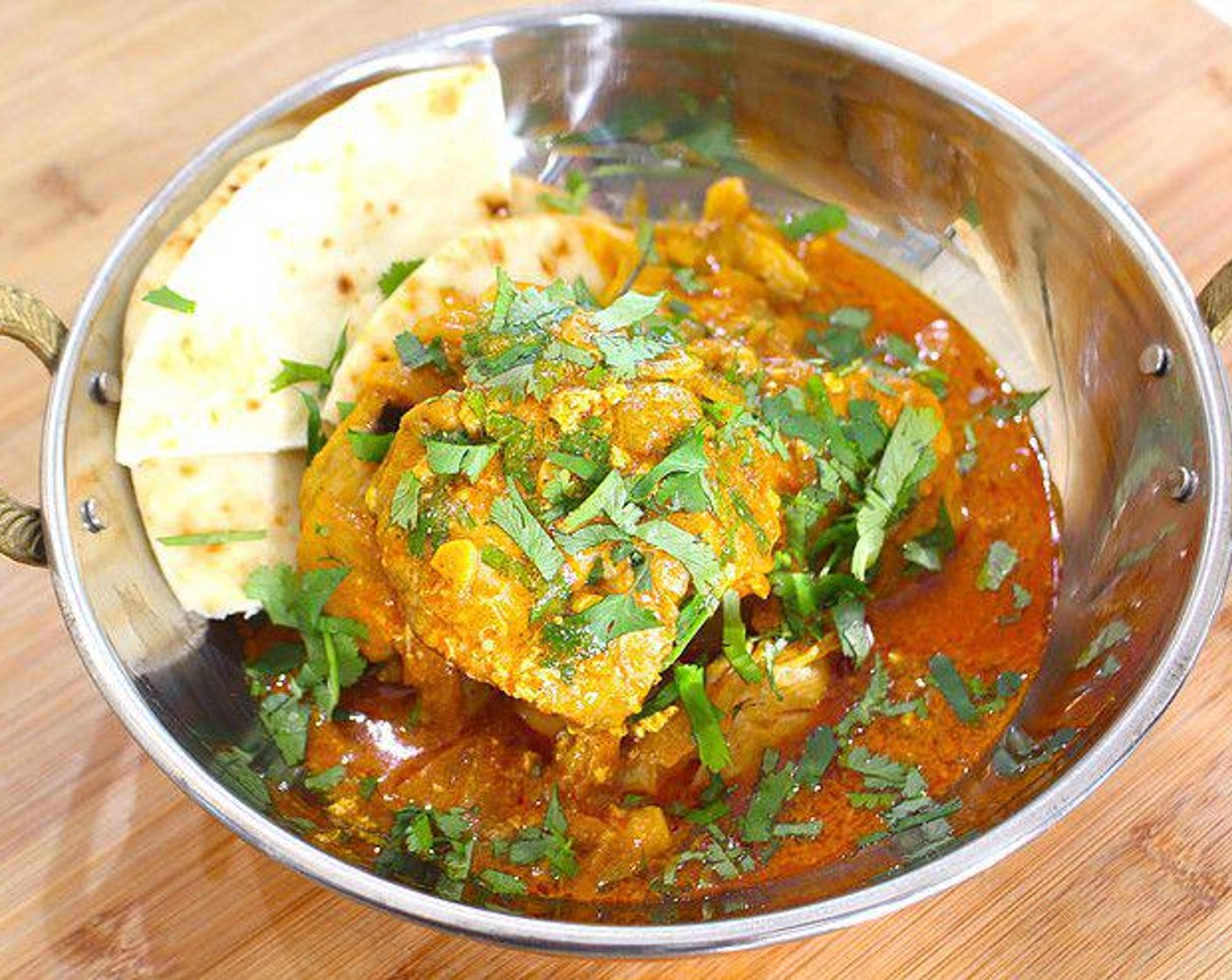 step 5 Serve with Naan bread or basmati rice and top with fresh cilantro. Enjoy!