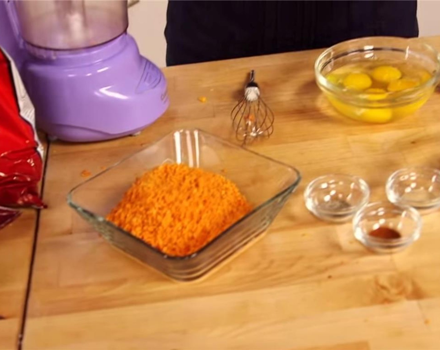 step 4 Set up a coating station: place cheese triangles to the far left-hand side, followed by flour bowl, followed by eggs wash, followed by Doritos. Finally, line a cookie sheet with parchment paper, and set on the far right-hand side.