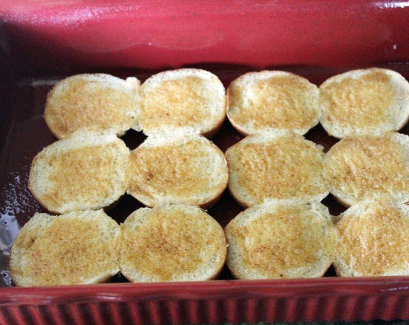 step 6 Place the bottom half of Slider Buns (12) in a baking dish. Brush the buns with half of the butter mixture.