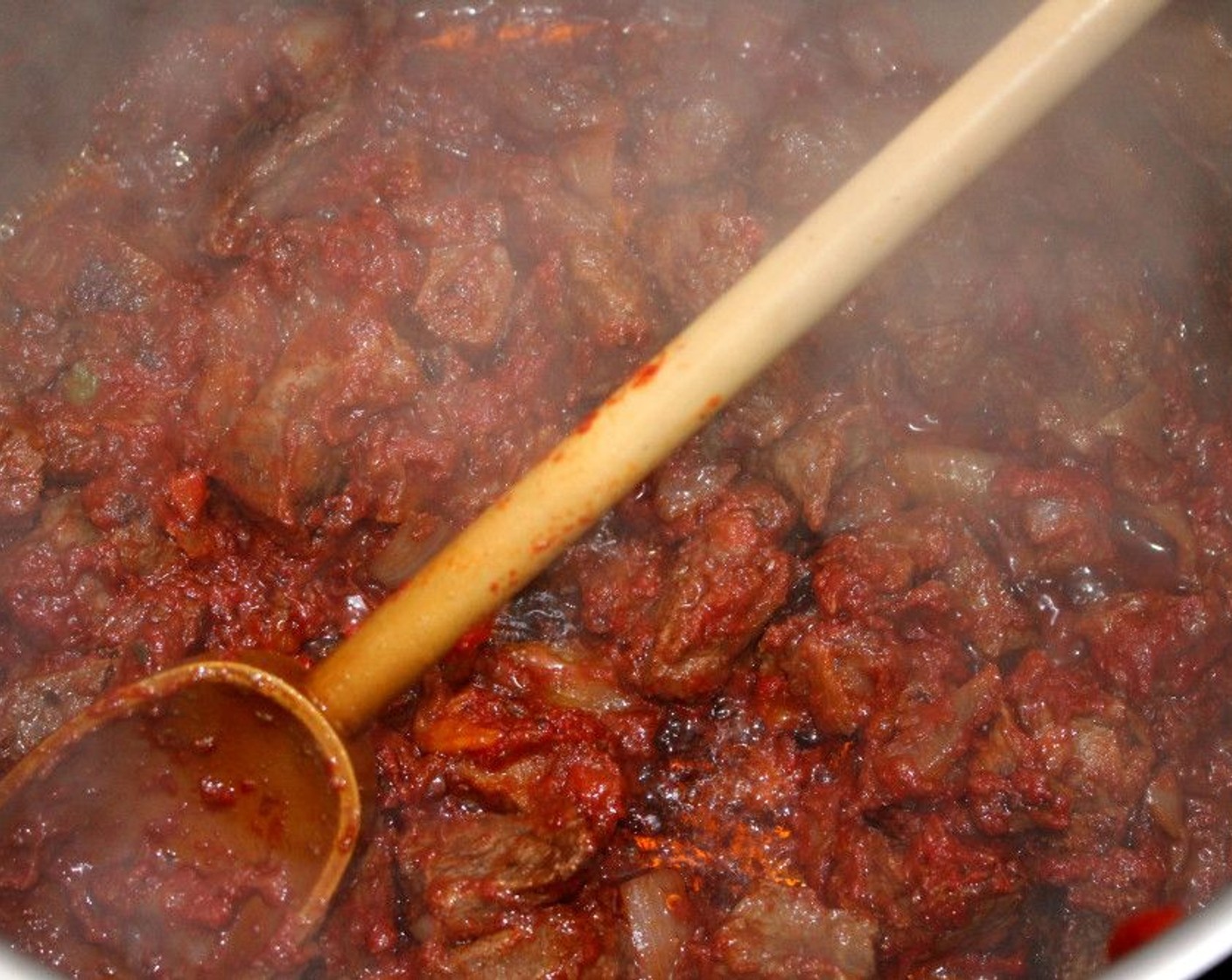 step 5 When the meat and onions start to brown, add the Tomato Paste (1 cup). Sauté until it starts to caramelize.