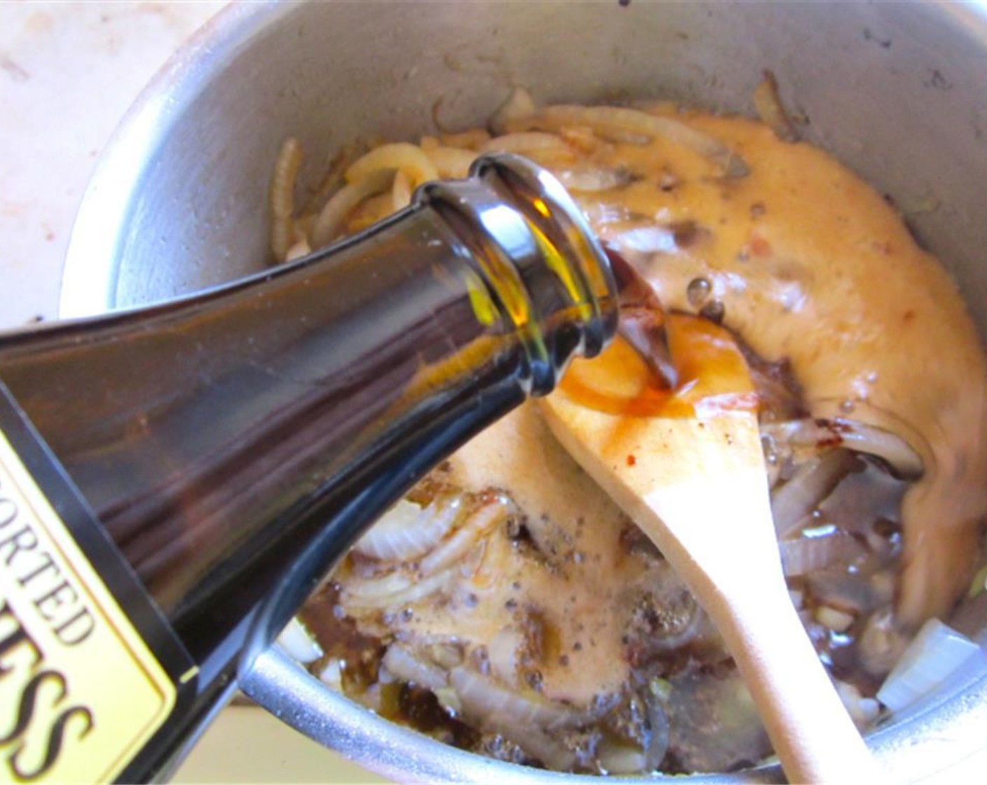 step 10 Add the Guinness® Stout Beer (12 fl oz) to the yellow onions and simmer until onions are soft but not mushy.