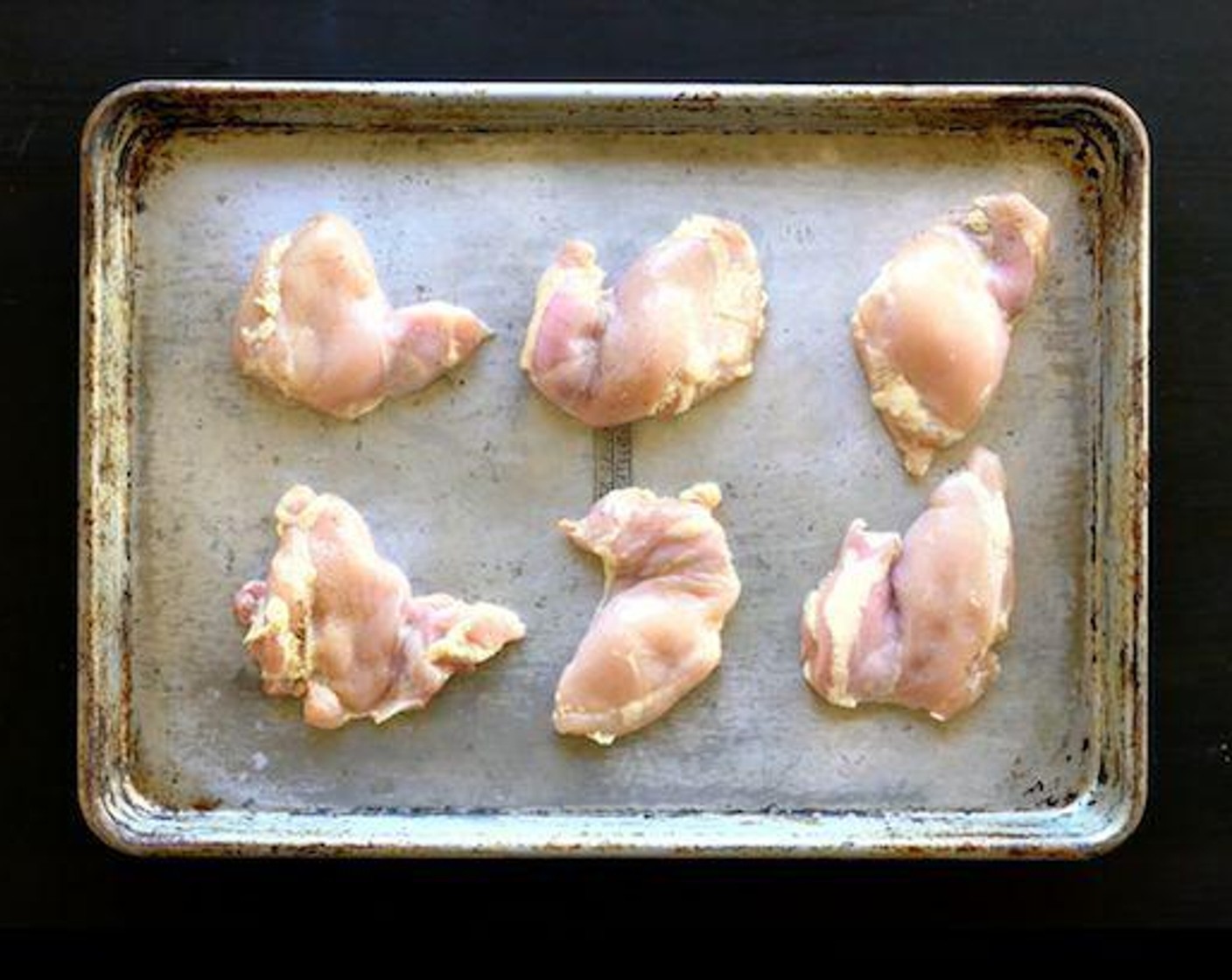 step 2 Toss the Boneless, Skinless Chicken Thighs (6) in Olive Oil (as needed) and season with Salt (to taste) and Ground Black Pepper (to taste). Place on a sheet pan. Bake 18-20 minutes.