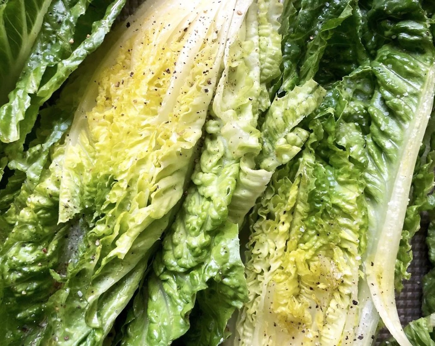 step 5 Drizzle the additional Extra-Virgin Olive Oil (1 Tbsp) on the cut side of each half of the Romaine Hearts (2) and season with additional salt and pepper.