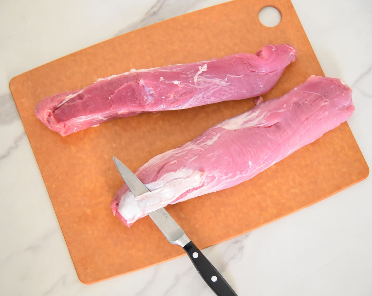 step 1 Place the Pork Tenderloin (1 pckg) on a cutting board. Pat the tenderloins dry with paper towels. Using a pairing knife, insert the knife under the silver skin on the tenderloin and slice along the meat to cut away any silver skin on the tenderloin. Each tenderloin will have a small spot of silver skin.