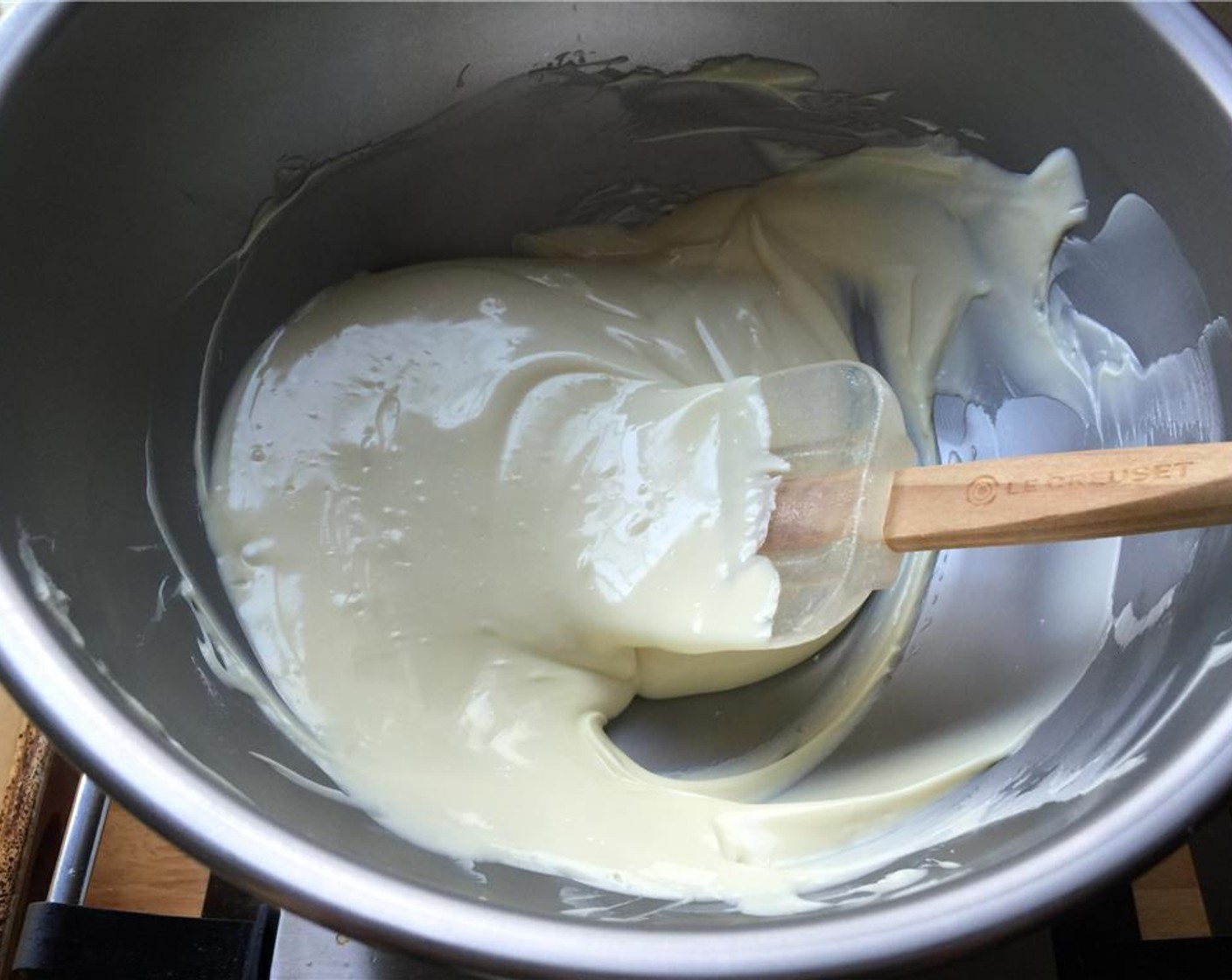 step 6 Place a heat resistant bowl over a pot of water to make a double boiler. Place the pieces of white chocolate in the bowl and melt.
