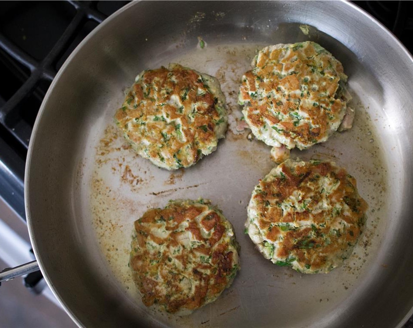 step 7 Heat the Extra-Virgin Olive Oil (2 Tbsp) in a large skillet over medium-high heat.  Cook the tuna burgers, 2-3 minutes per side –  don’t overcook the burgers or they will be dry.  Transfer to a clean plate to rest.