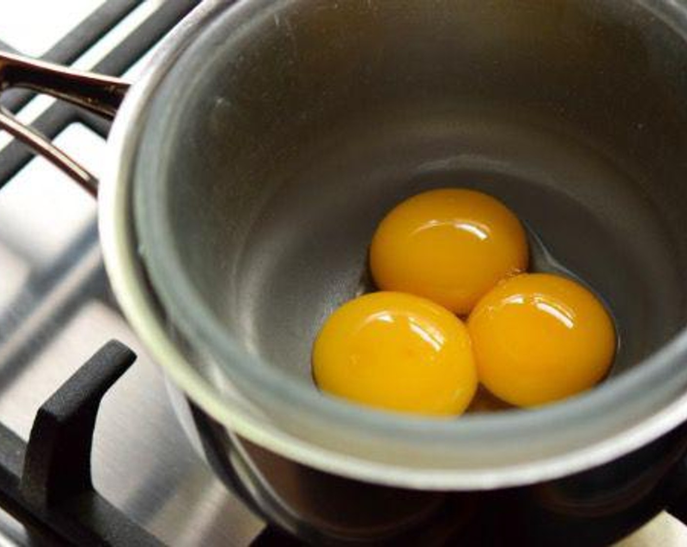 step 1 In a bain marie or double-boiler, add just the yolks of the Eggs (3) and juice from Lemon (1). Using a small whisk, beat the yolks and lemon juice together until they form a sabayon. This happens when the lemon juice emulsifies the egg yolks and they thicken and take on a lighter hue. To know when you’ve reached this point, the mixture should cling to the whisk and you should be able to see the bottom of the glass bowl when you drag your whisk through it.