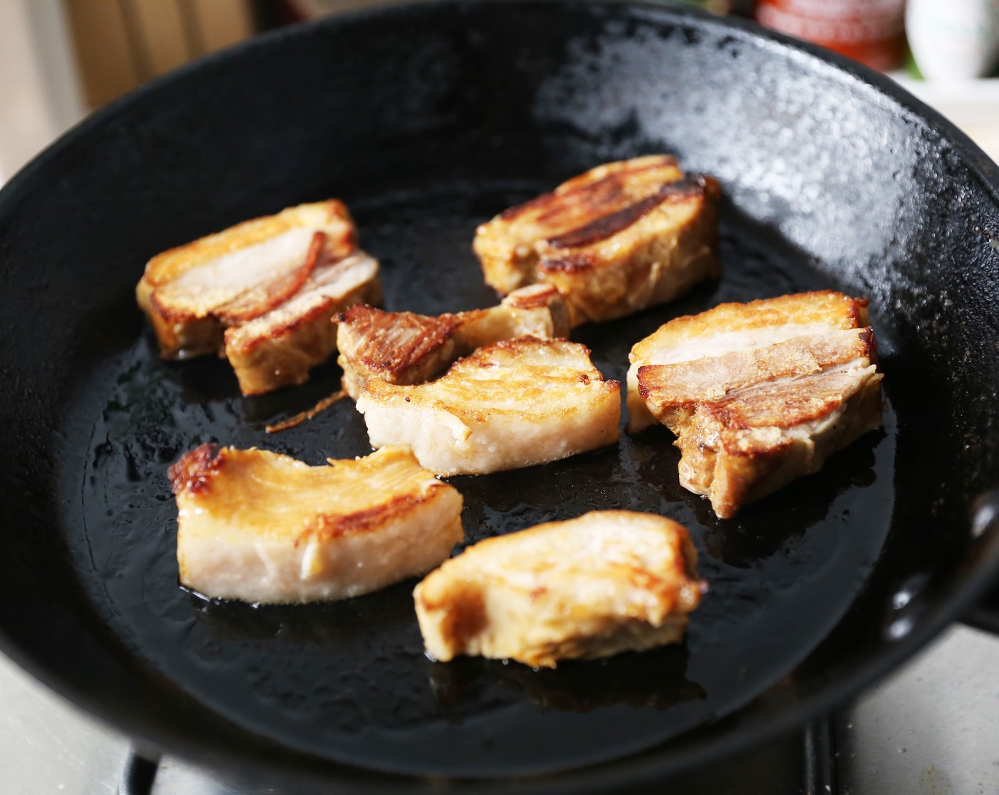 step 8 Heat a sauté pan over medium, high heat. Add Canola Oil (1 tsp) and quickly sear braised pork pieces.