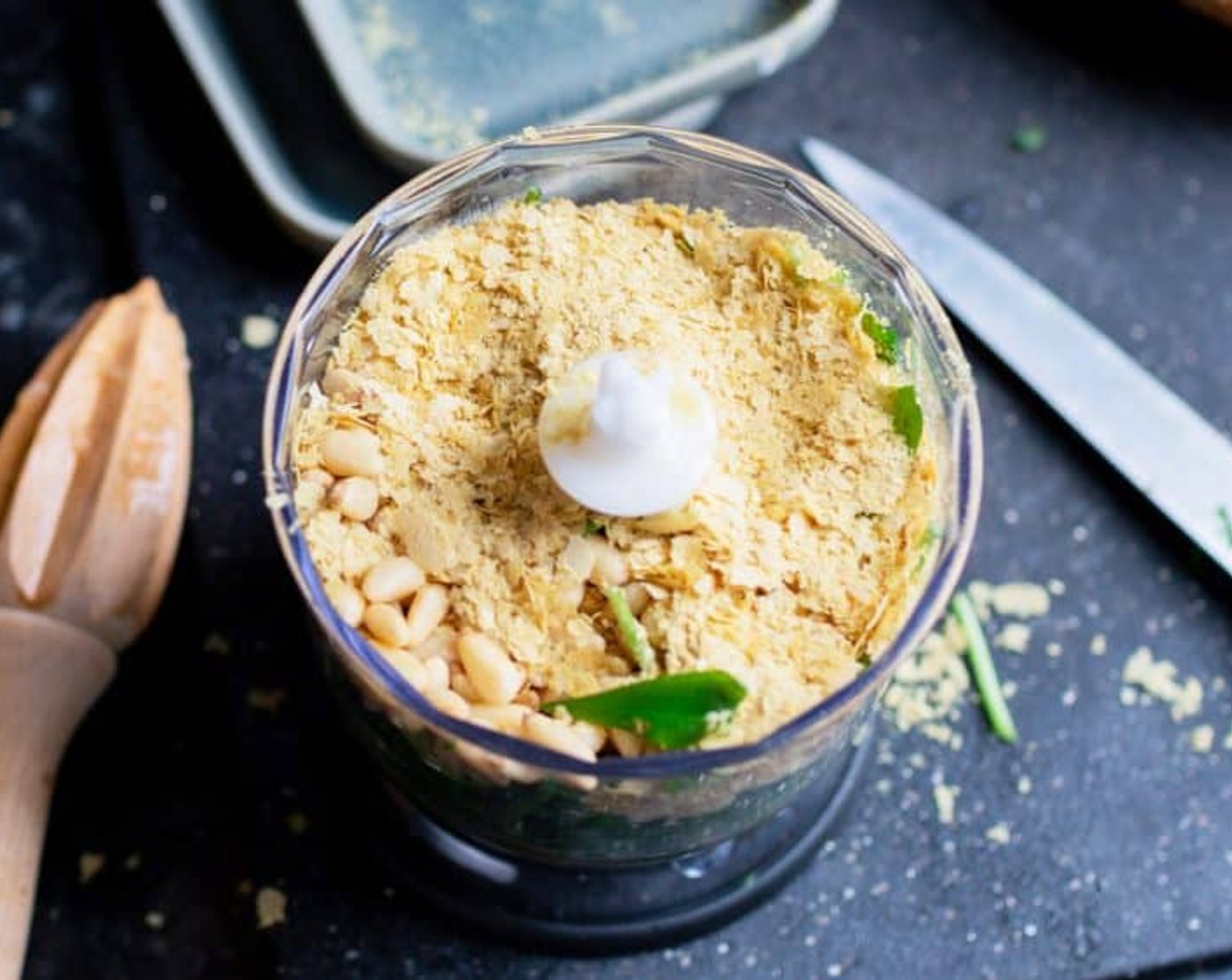 step 1 Add Wild Garlic (3/4 cup), Pine Nuts (2 Tbsp), Nutritional Yeast (1 Tbsp), Olive Oil (2 Tbsp), Garlic (1 clove), 1/2 Tbsp of Lemon Juice (1), Salt (1/2 tsp) a small food processor.