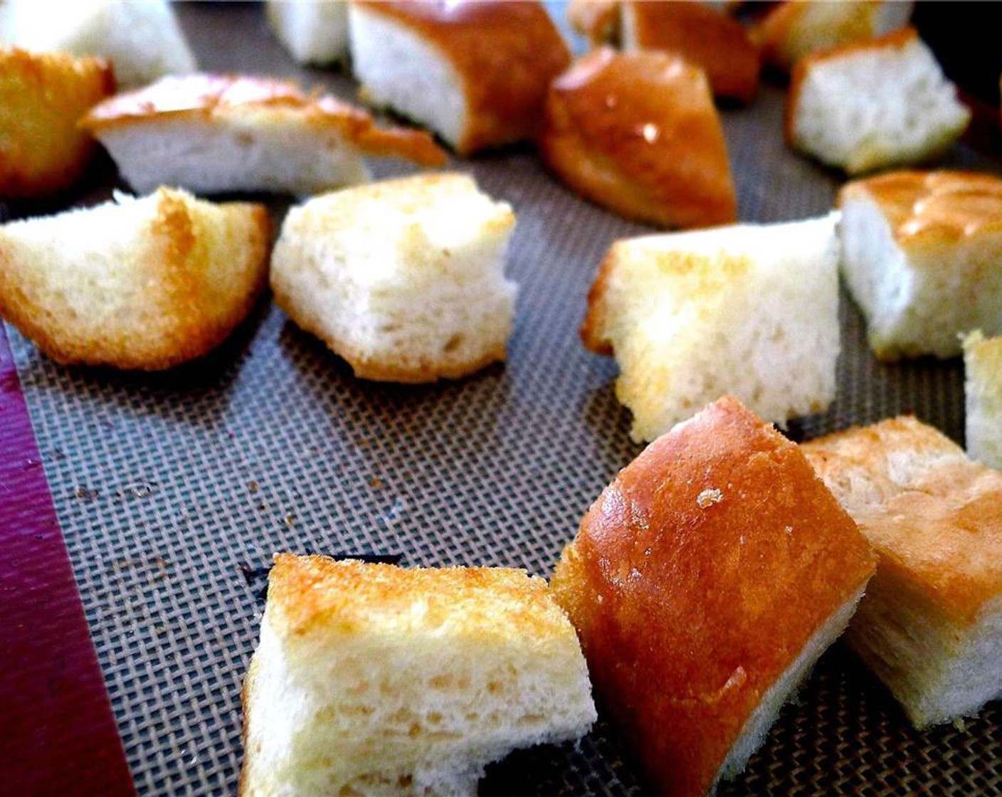 step 7 Carefully remove the hot baking sheet from the oven and flip the bread cubes. Place back into the oven and bake for another 8 minutes, or until golden brown. Then, remove and set aside.