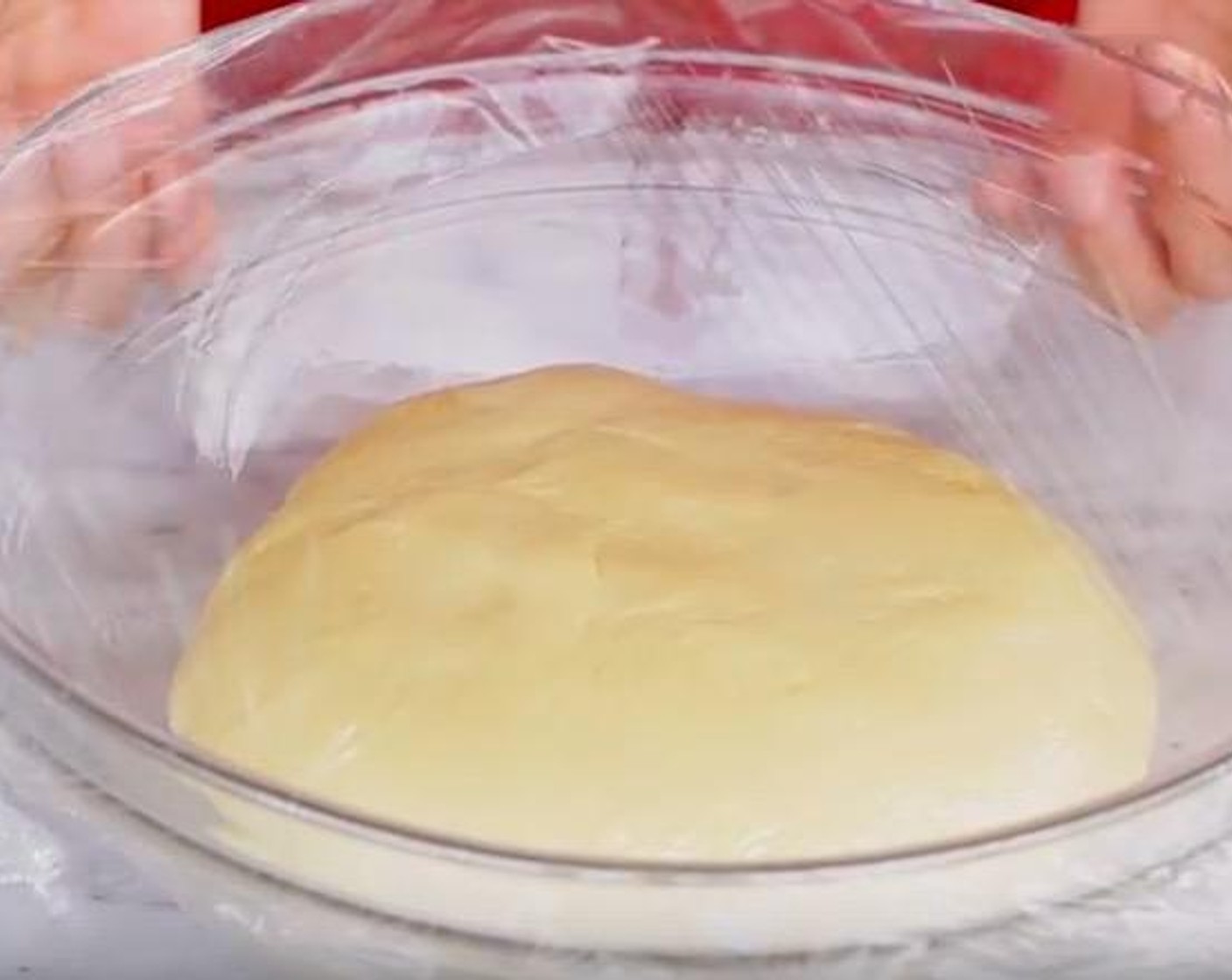 step 6 Form dough into a ball and place in a bowl greased with oil. Coat the top and bottom of the dough with oil. Cover with plastic wrap and a dish towel. Place somewhere warm and let rise for 1 1/2-3 hours.