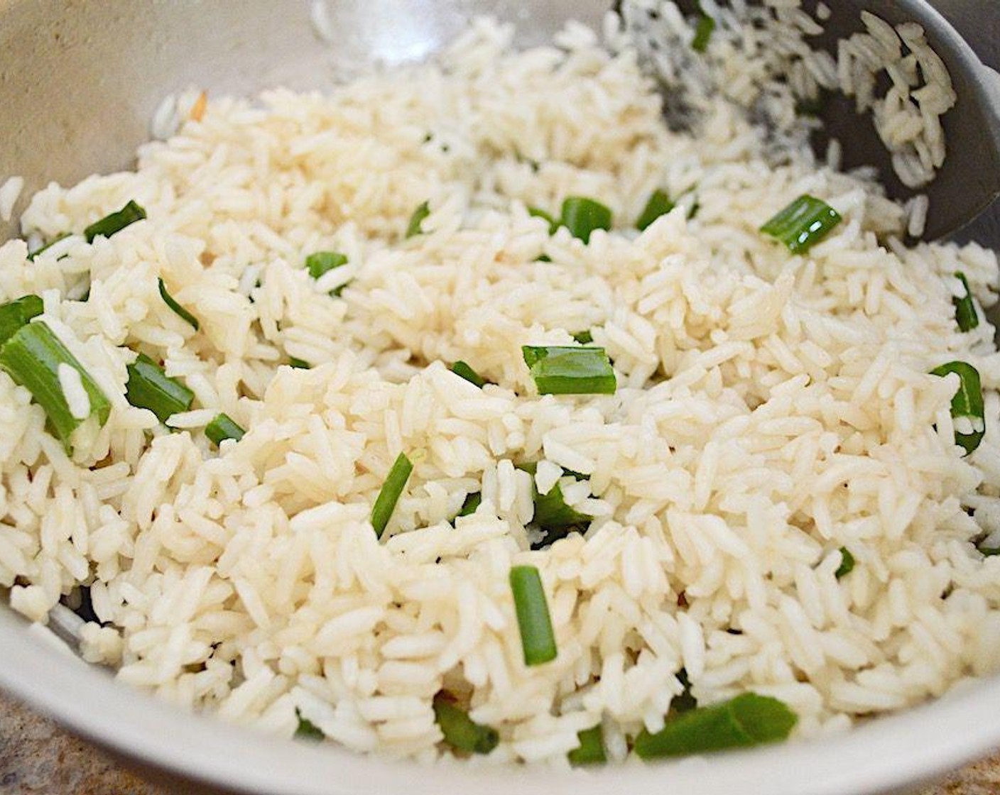 step 4 Let the rice cook until tender for about 15 to 20 minutes. When it is done, stir in the Scallion (1/2 cup) and let them get fragrant in the hot rice.