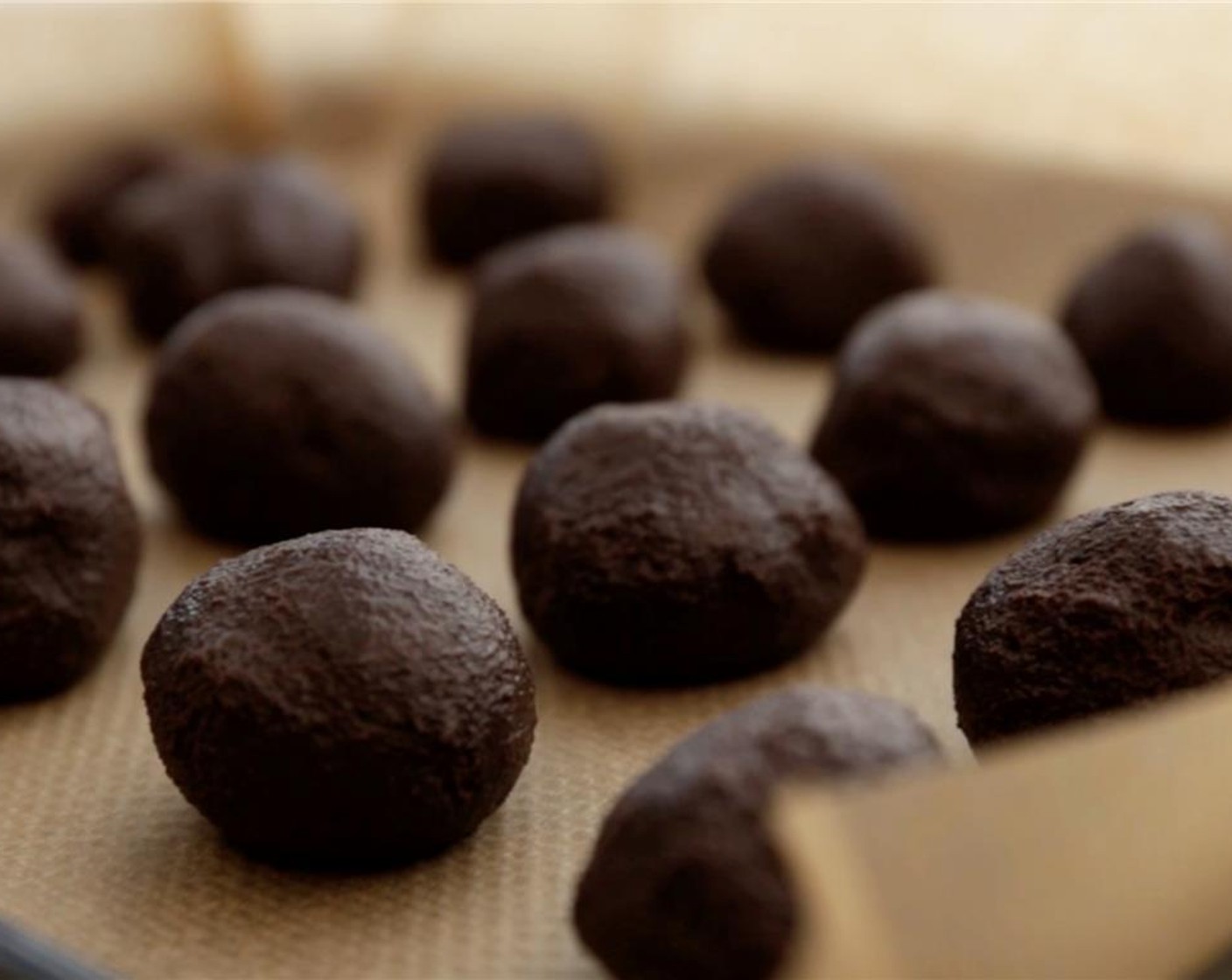 step 4 Scoop 1 tablespoon balls of truffle dough and them into a ball. Then place onto a wax paper lined cookie sheet. Chill for at least one hour.