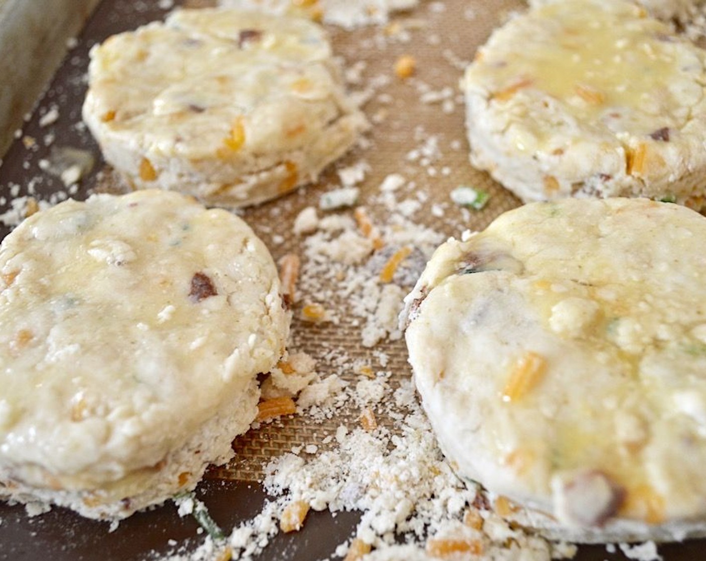 step 5 Bring the mixture together into a ball with floured hands, then press it out into a large disc that is about 1 inch thick. Use a 3 inch biscuit cutter to cut out as many scones as you can get, keeping the cuts close together.