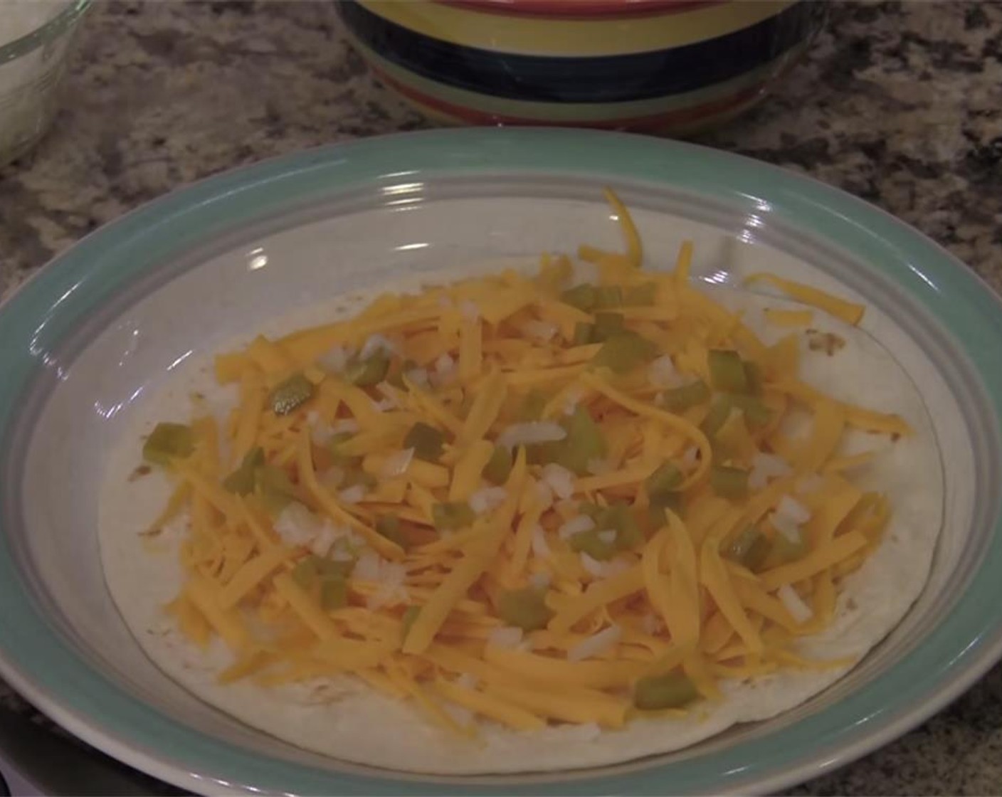 step 2 Sprinkle with Green Chili Pepper (1) and Onion (1 Tbsp) and top with the other Flour Tortilla (1).