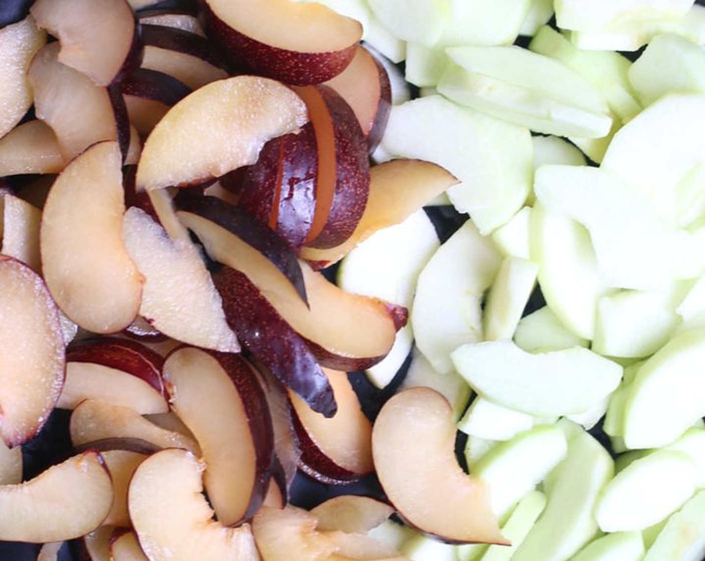 step 2 In a medium bowl, toss the Honeycrisp Apples (9 cups) and Plums (5 2/3 cups) with juice from Lemon (1).