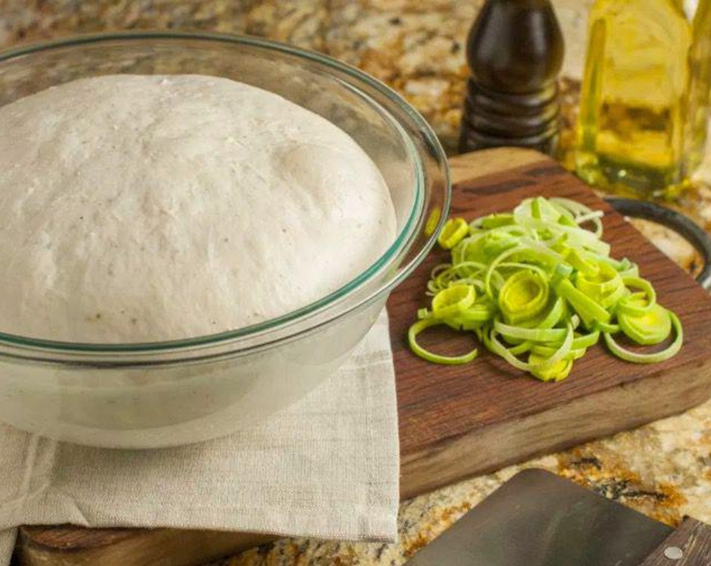 step 4 Place dough in a large oiled bowl and cover with plastic wrap or kitchen towel. Allow to rise in a warm, draft-free area until double in size, approximately 1 hour.