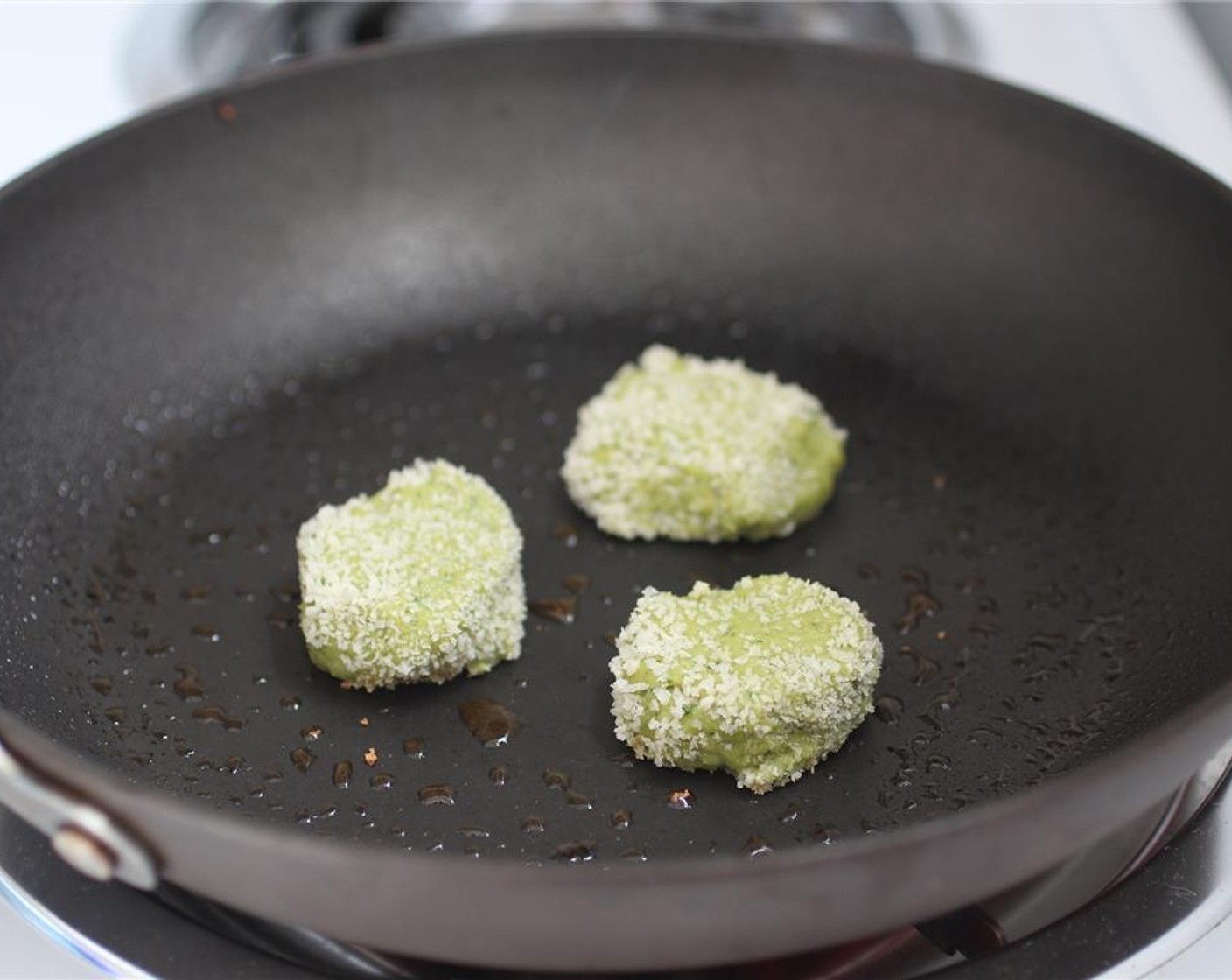 step 5 Put Canola Oil (2 Tbsp) into a skillet on medium-high heat. Allow the oil to heat until a splash of water on the pan results in the oil spitting. Then place 1-3 cheese balls in the pan and fry. Flip and brown the other side.