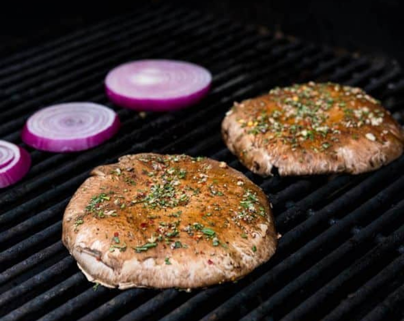 step 12 Place the mushrooms on the grill, cap side down, and cook for 4-5 minutes. Grill the red onions at the same time. Flip the mushrooms and onions and cook for an additional 3-4 minutes, until the flesh is softened and the exterior takes on some grill marks.