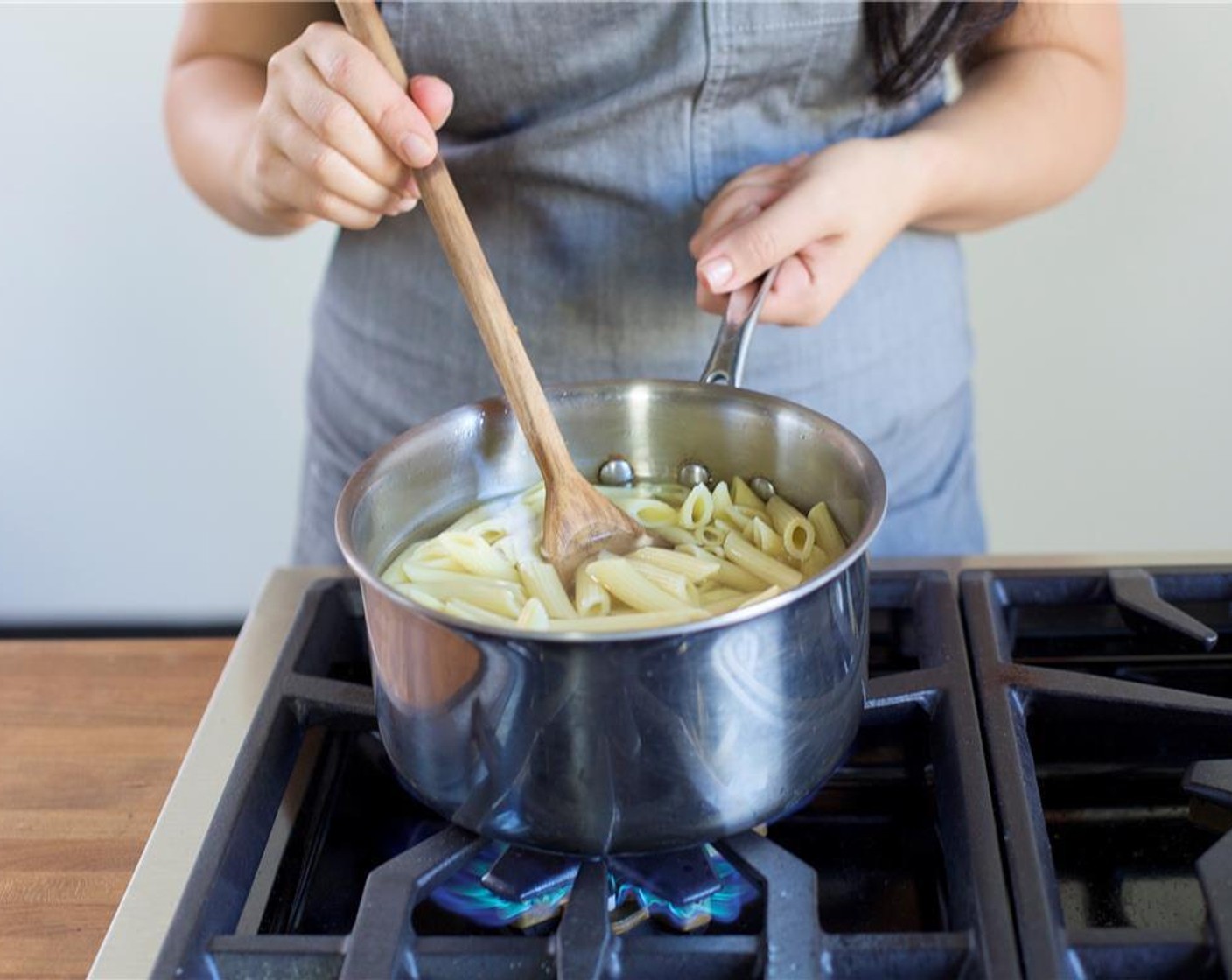 step 5 When water reaches a boil, add Penne Pasta (8 oz) and stir. Cook for 11 minutes, or until desired texture. Drain pasta into a colander and then return to the large pot, placed over medium low heat.