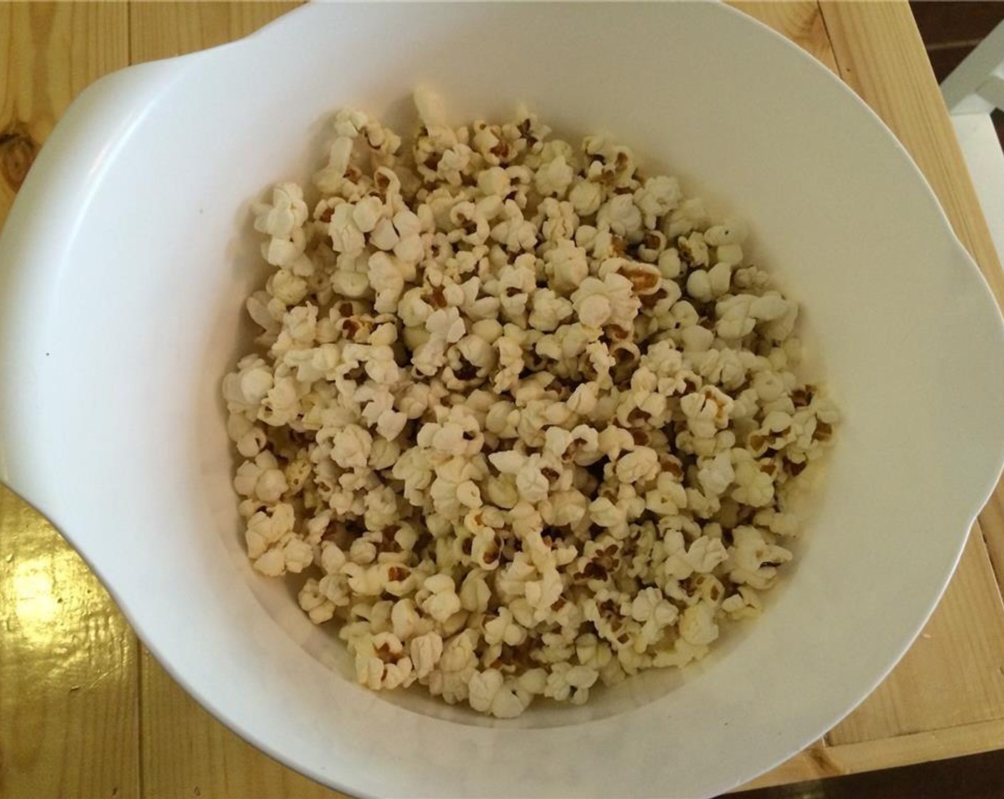 step 9 Pour the popcorn into a bowl and season with Salt (to taste). If you'd like, drizzle with Olive Oil (to taste). Then shake vigorously so the popcorn is evenly coated.