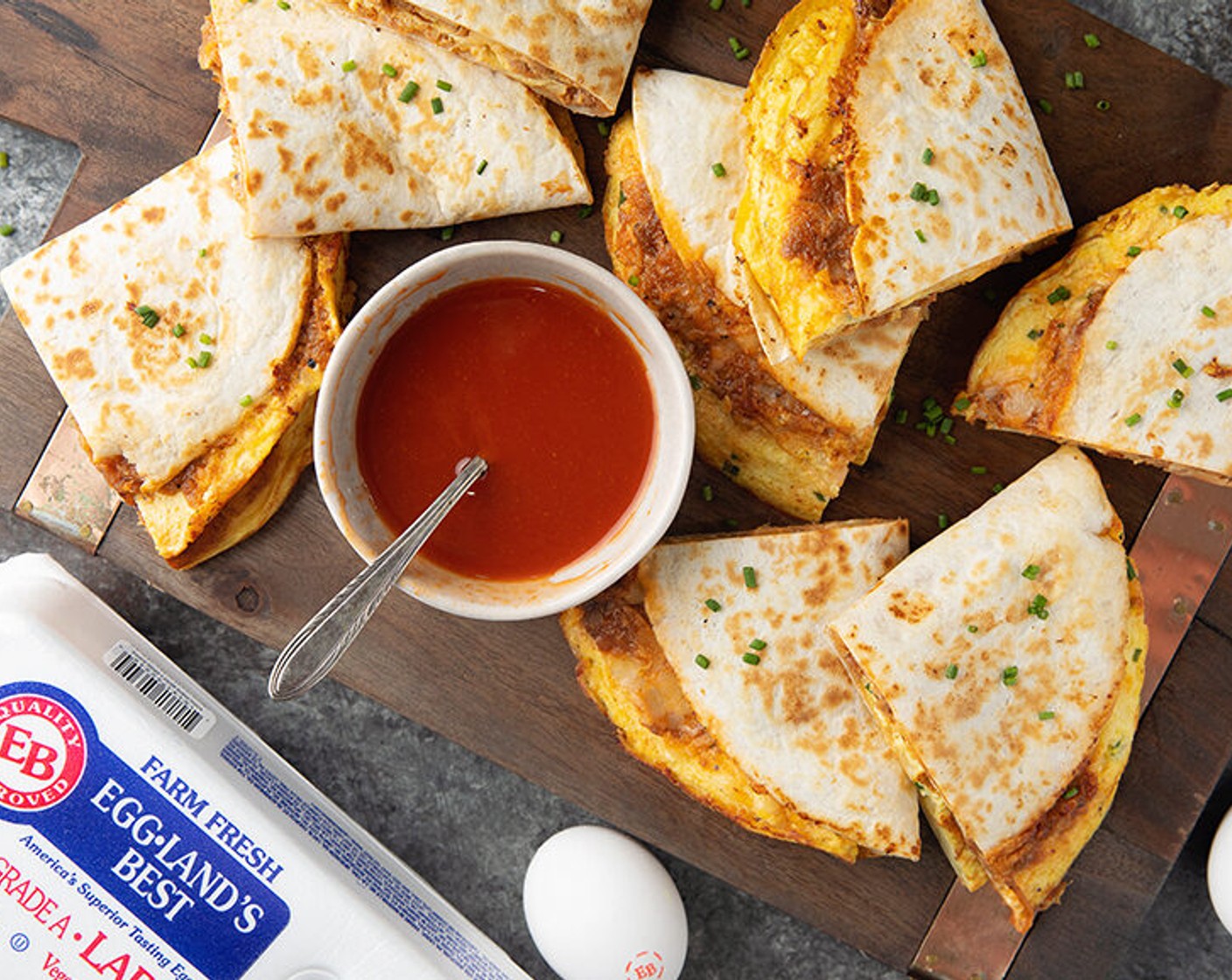 step 4 In a fry pan with an 8-inch bottom, melt about ½ tbsp. Butter (3 Tbsp). Pour in ½ cup Eggland’s Best eggs and ricotta cheese mixture. Cook on medium heat until just set, about 1-2 minutes. Top with 1/3 cup BBQ meat and ½ cup of Shredded Mozzarella and Provolone Cheese Blend (3 cups). Lay one 8-Inch Flour Tortillas (6) on top and press down so it will stick to meat, cheese, and eggs. Flip over to brown the tortilla, about 30 seconds. Fold in half and serve.