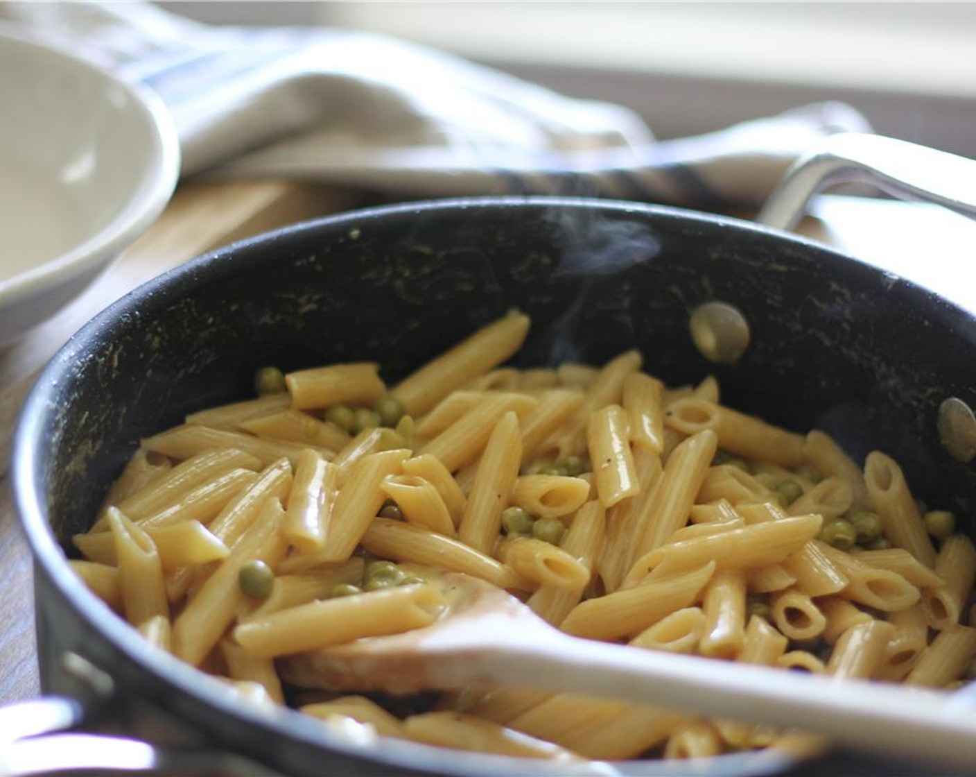 step 10 Stir in Green Peas (1 cup), Kemps Heavy Whipping Cream (8 fl oz), and remaining parmesan cheese. Cook and stir about 2 minutes or until heated thorough.