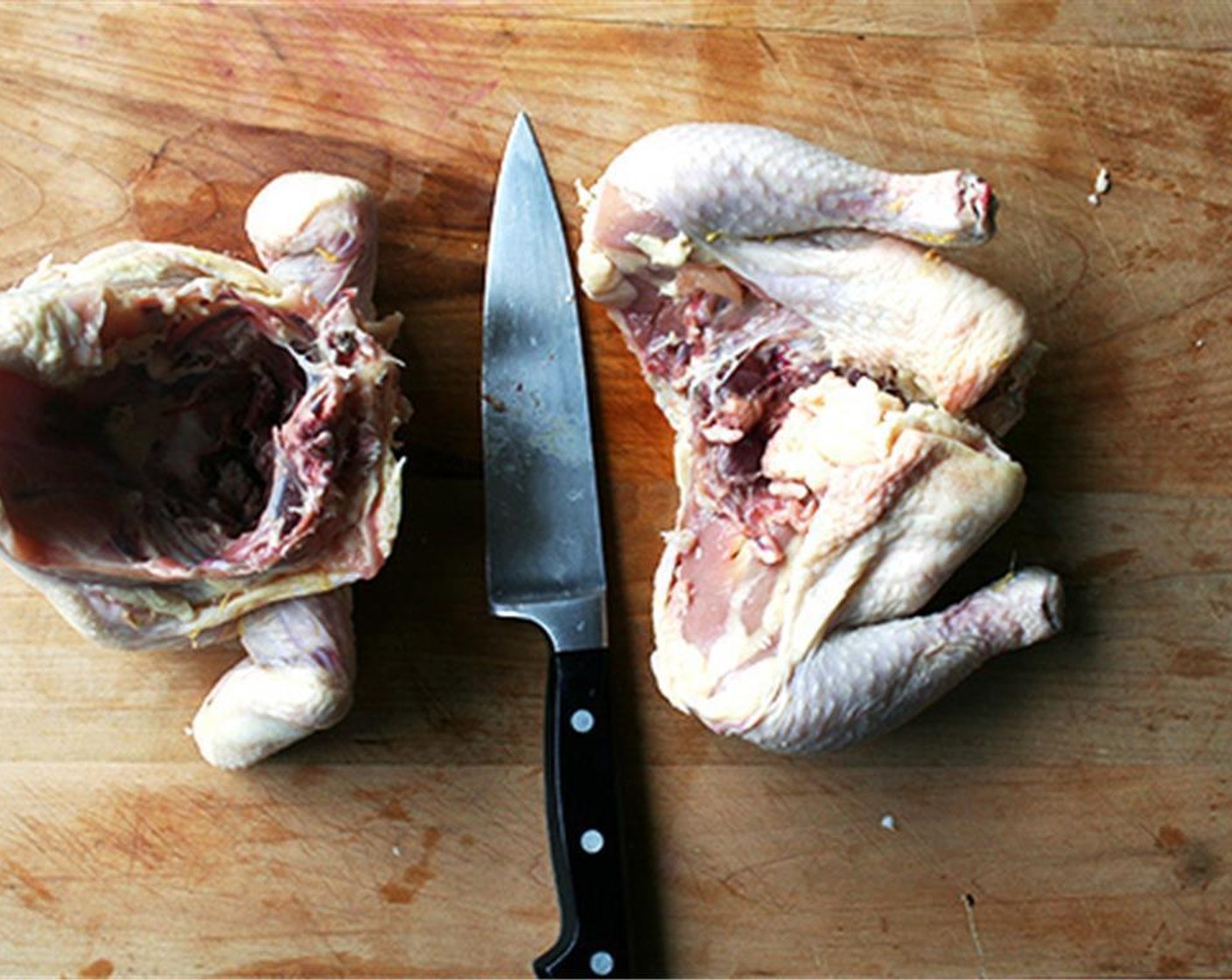 step 2 First, cut the chicken in half.