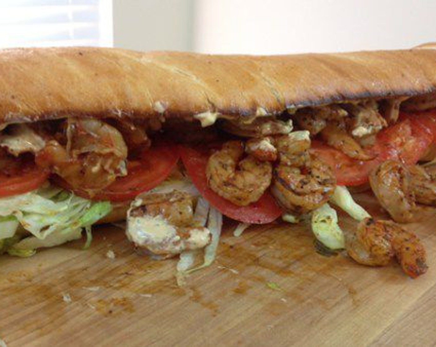 step 9 Smear the BBQ Remoulade on the top half of the French Bread and place it on top. Serve the rest of the sauce on the side for dipping any escaping shrimp. Serve and enjoy.