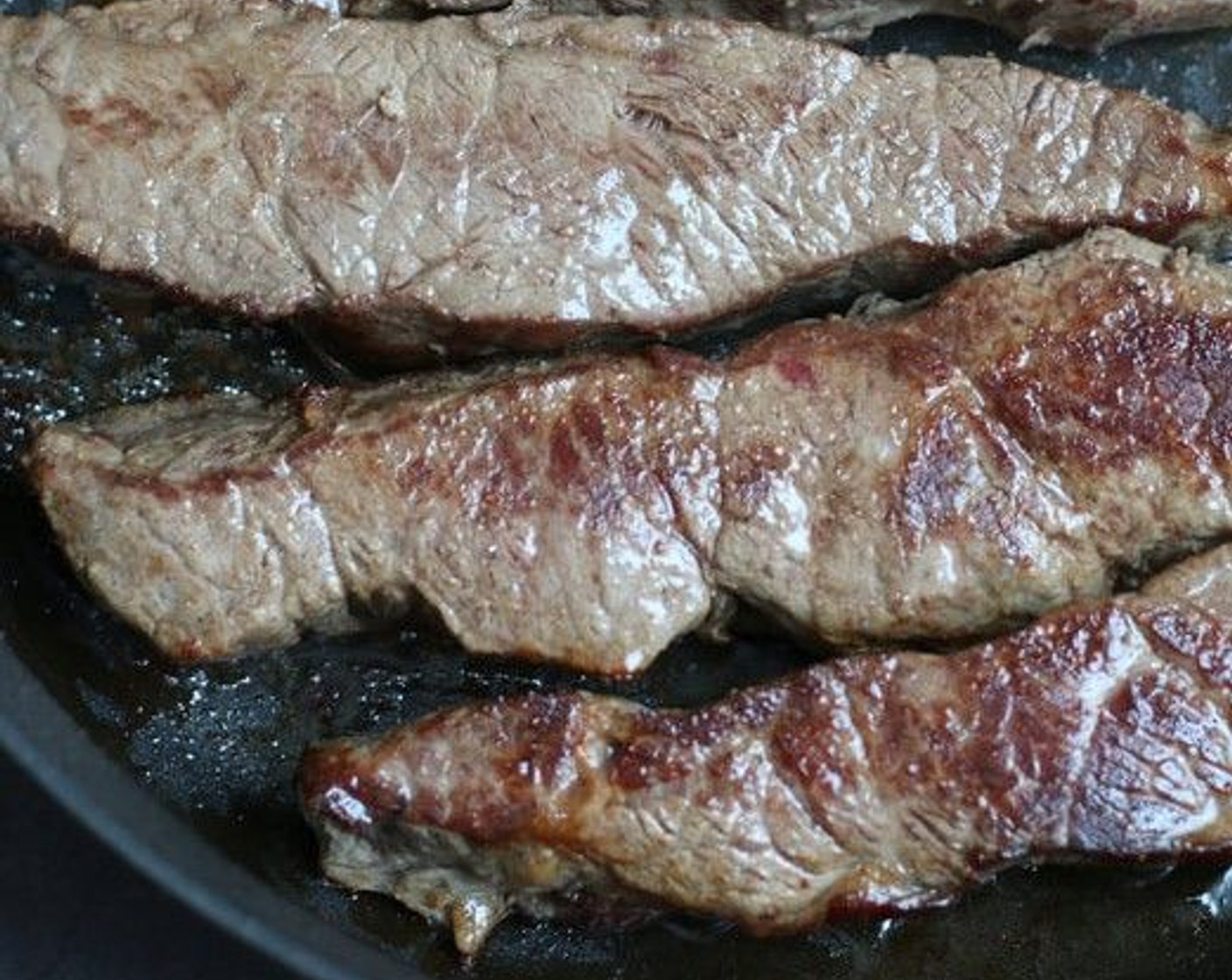 step 2 Heat Olive Oil (3 Tbsp) in a large heavy skillet over medium-high heat. Season Boneless Beef Short Ribs (3 lb) on all sides with Salt (to taste) and Ground Black Pepper (to taste). Working in batches, sear short ribs on all sides until deeply and evenly browned, 2 to 3 minutes per edge.