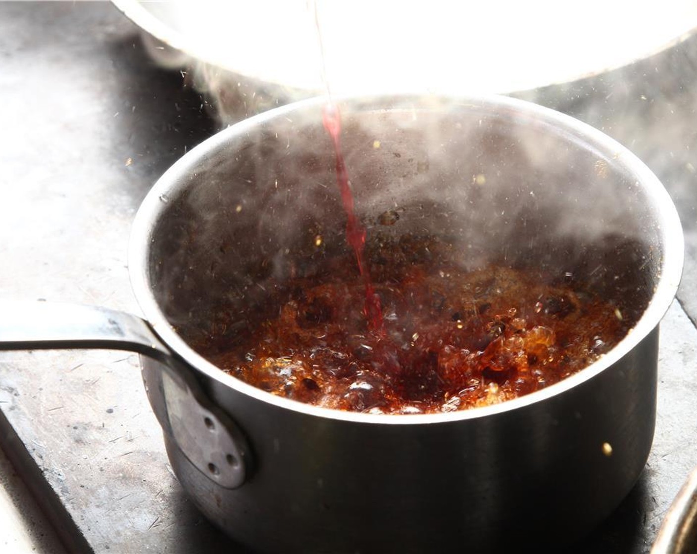 step 19 Remove from flame and carefully add Cranberry Juice (5.5 oz) and Red Wine Vinegar (5.5 oz), mixture will bubble, place back on heat until your sauce coats the the back of a spoon.