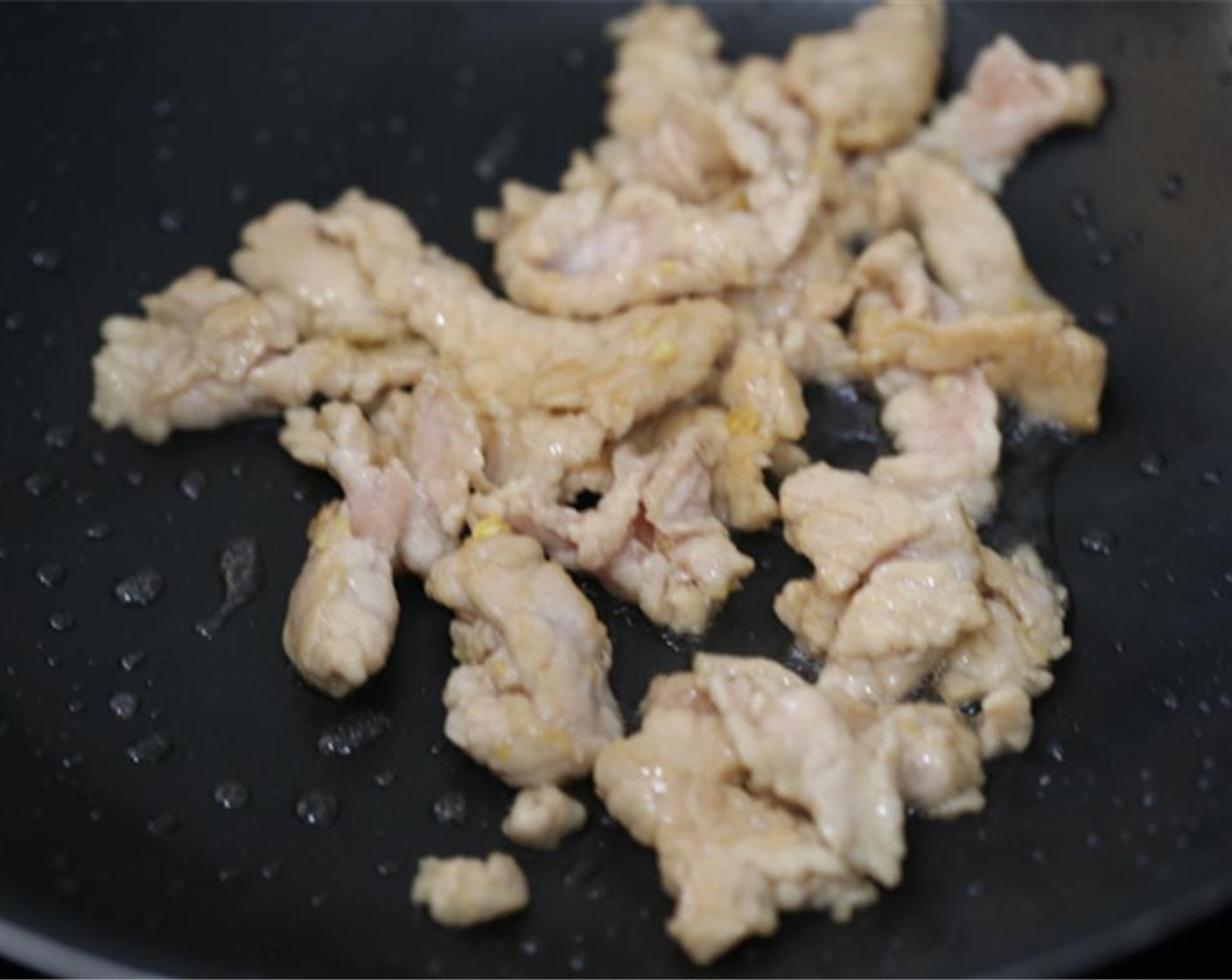 step 5 Heat your wok or pan firstly. Add Cooking Oil (3 Tbsp). Spread the pork slices in when the oil begins to warm but not hot. Let them stay for around 5-8 seconds and then quickly fry them until turns pale. Transfer out immediately.