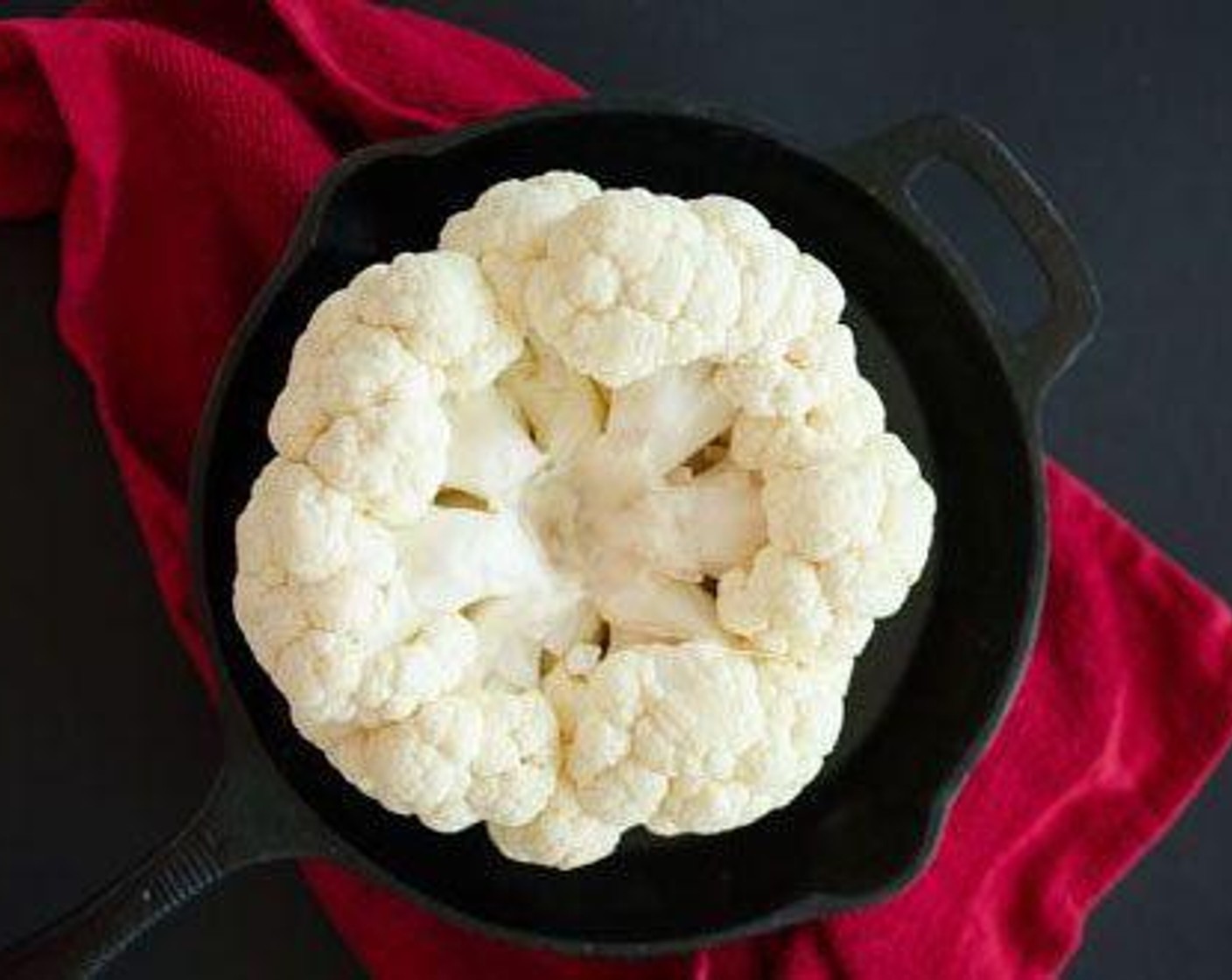 step 2 Rub Olive Oil (1/2 cup) all over the top and bottom of the cauliflower, using your hands to work it into the small grooves.