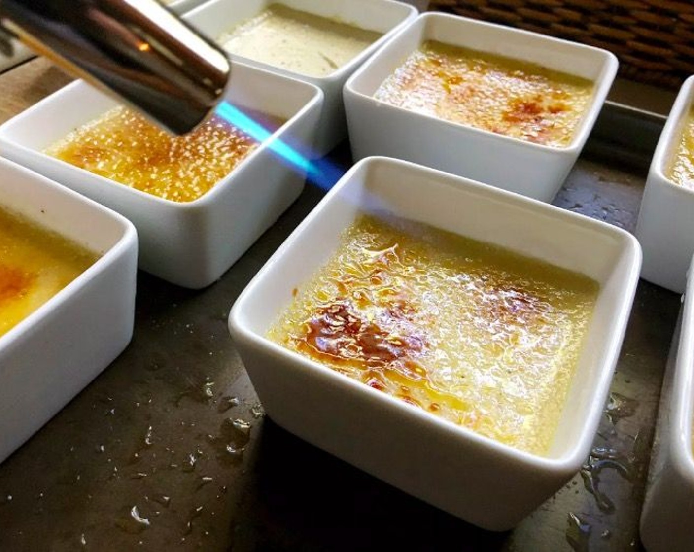 step 7 Remove from the refrigerator. Sprinkle surface of each custard evenly with remaining Granulated Sugar (1/2 cup). Caramelize the sugar with a kitchen blowtorch, moving flame quickly back and forth across custard.