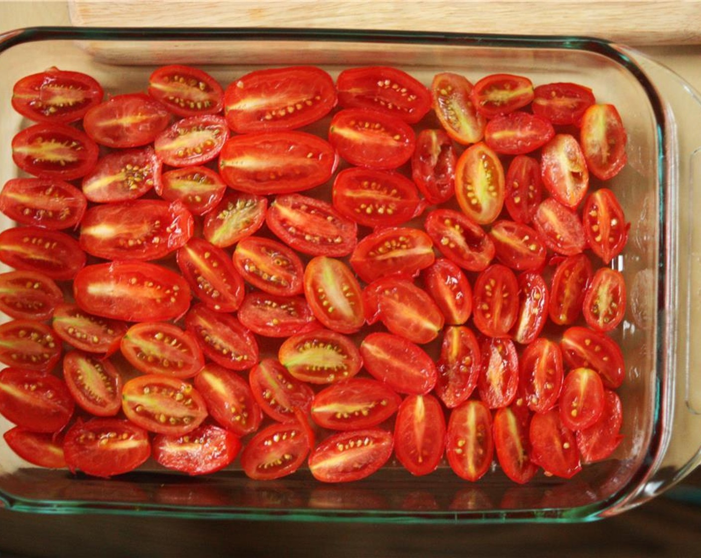 step 3 Wash Cherry Tomatoes (3 cups) and pat dry. Slice each tomato in half and place them in the baking dish, skin-side down, to form a single layer in the baking dish. Fit in as many tomatoes as you can.