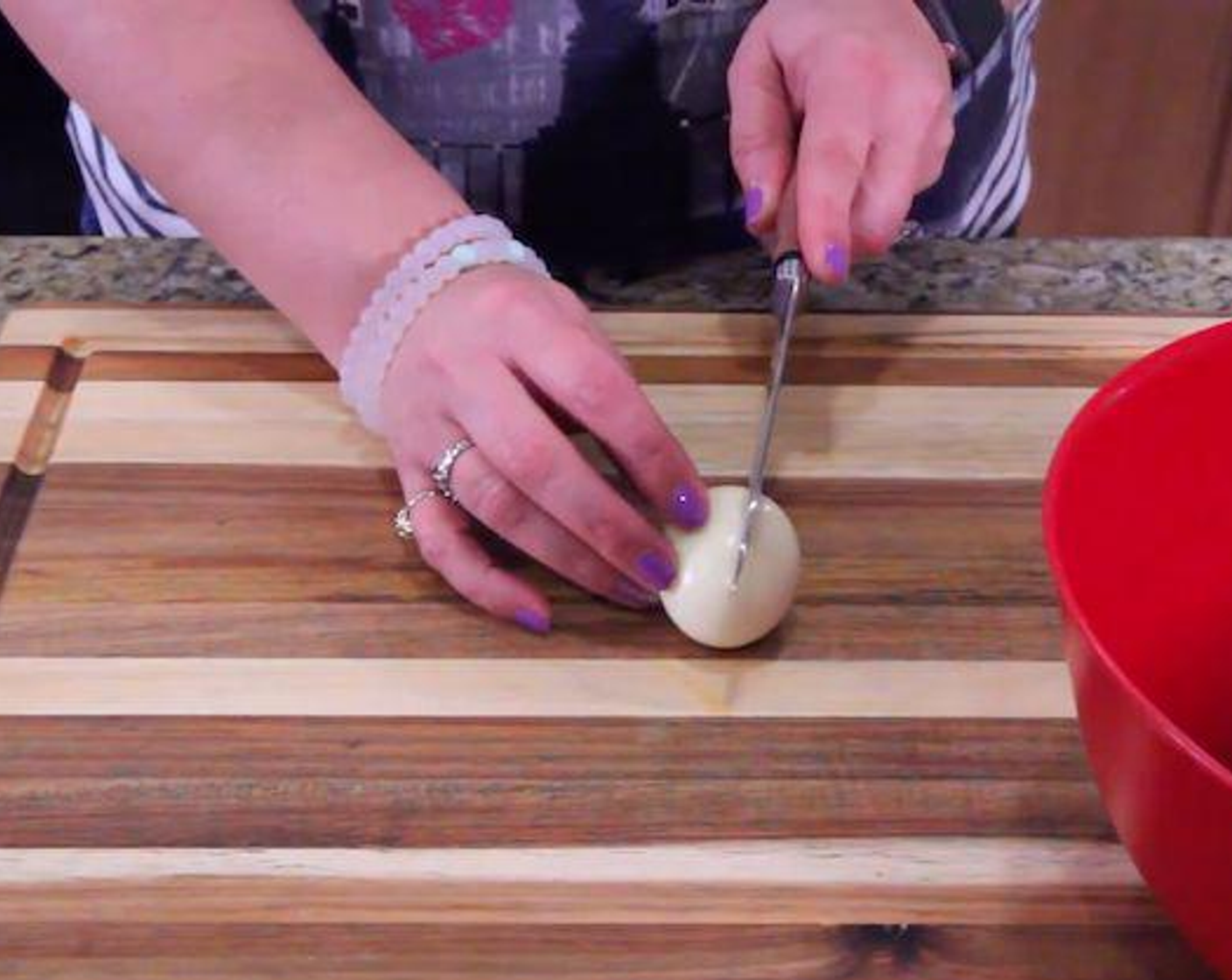 step 3 Once cool enough to handle, slice in half. Carefully scoop the yolks into a medium bowl.