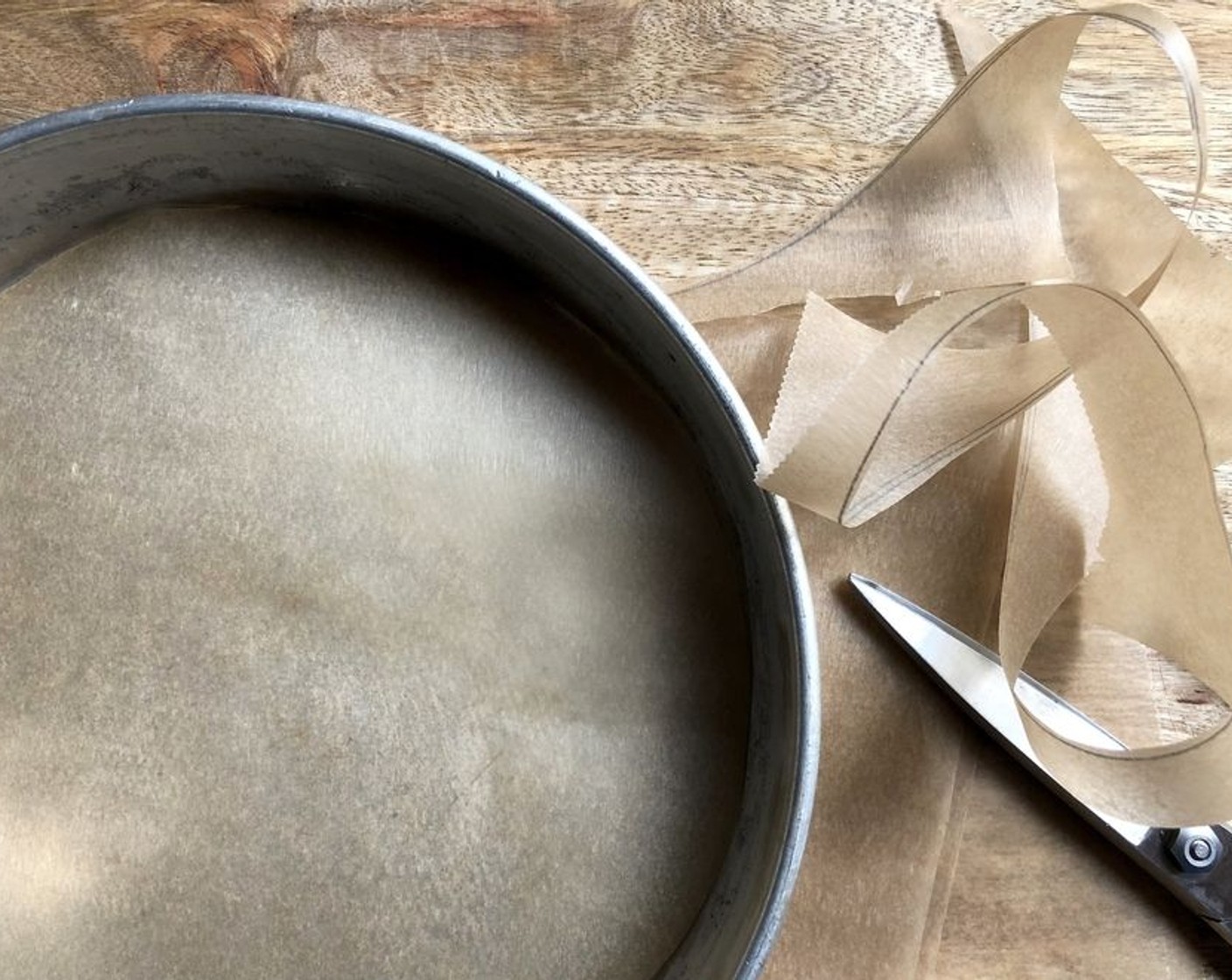 step 2 Lightly grease a nine-inch round cake pan and line the bottom with parchment paper.