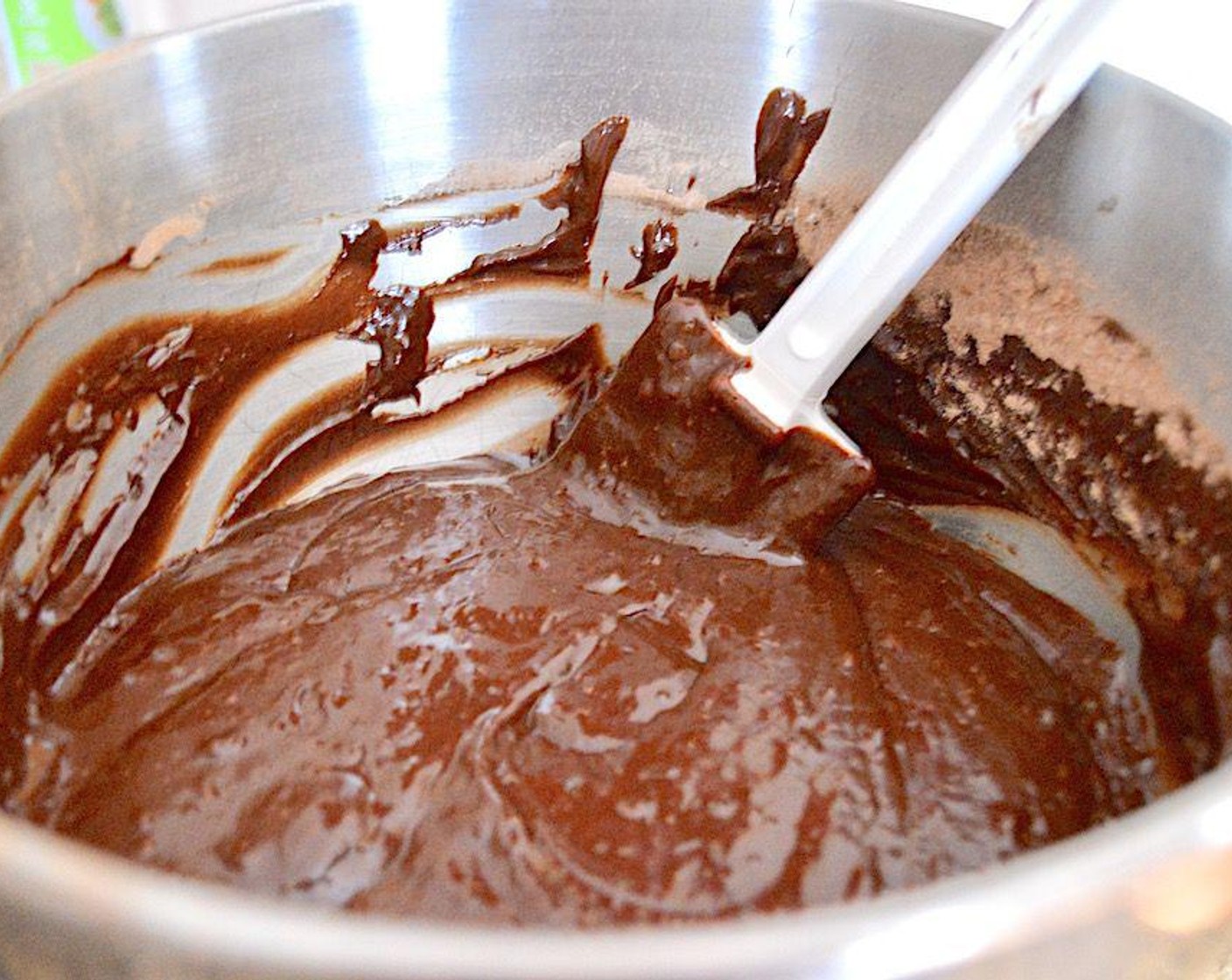 step 4 Combine the Semi-Sweet Baking Chocolate (1 1/3 cups), Fig Jam (3/4 cup), Butter (1/3 cup), and Milk (1 Tbsp) in a heatproof bowl and place it over the simmering water to form a double boiler. Let it melt and become shiny, stirring it with a heatproof spatula or spoon. Take it off the heat when it all smooth and melted and let it cool for a few minutes.