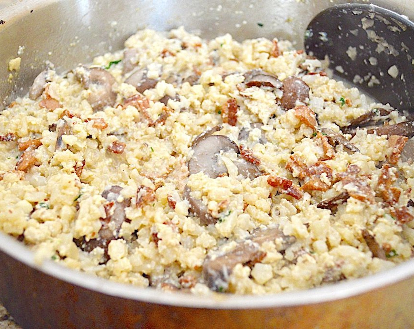 step 6 When the cauliflower rice is tender, pour in the sauce and stir continuously until the eggs cook through and the sauce is thick but not scrambled. This only takes 2-3 minutes.