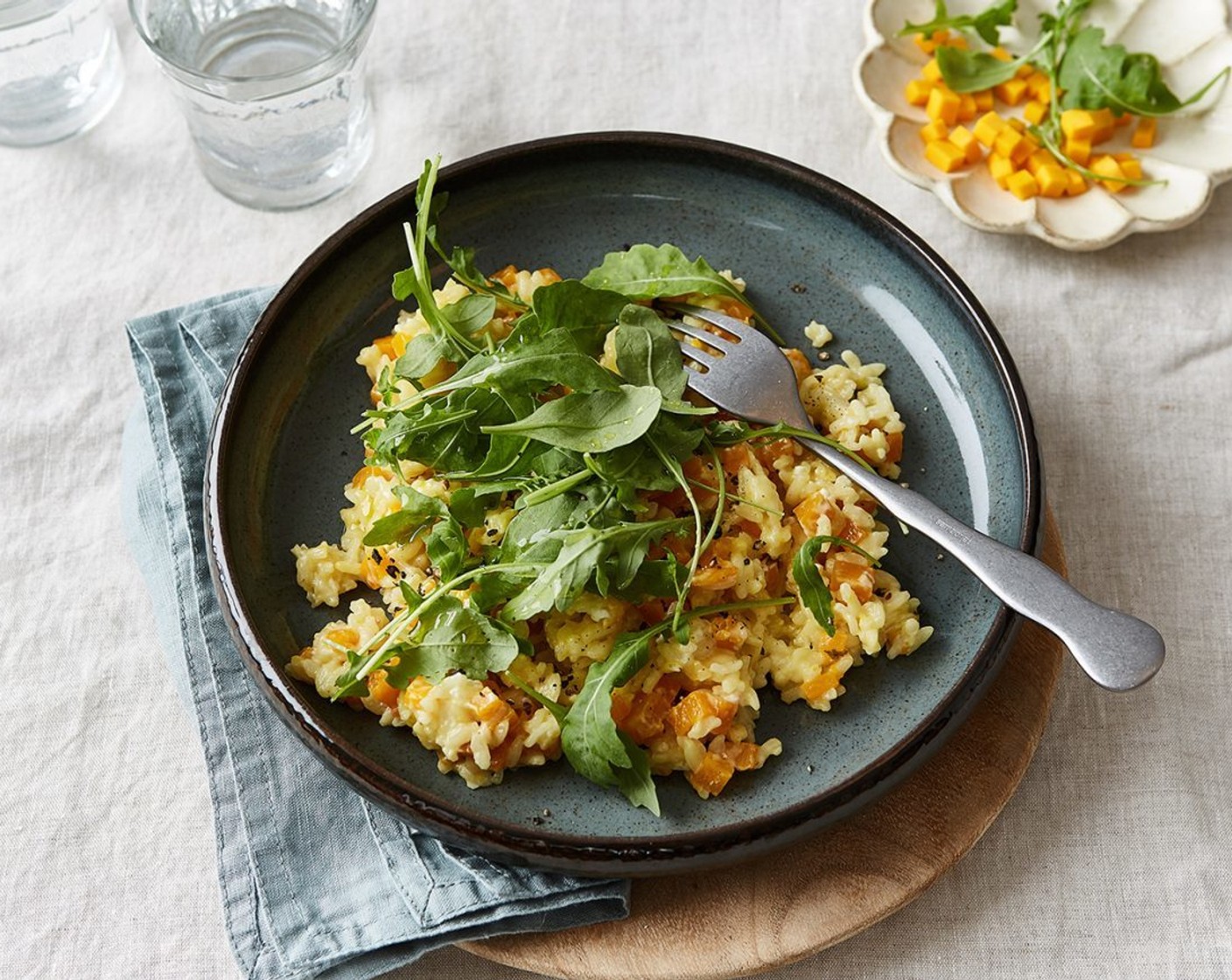 step 4 Arrange risotto in wide shallow bowls and garnish each with a little fresh Arugula (1 handful).