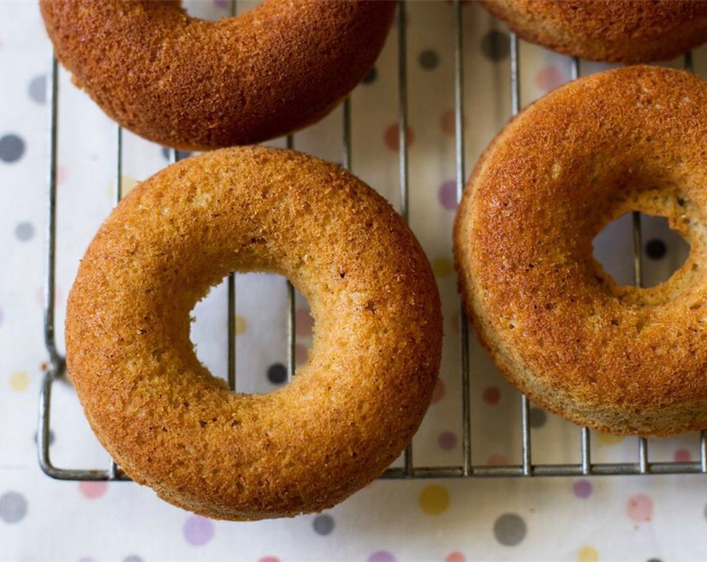 step 7 Let cool in the pan for 5 minutes. Slide a thin spatula around the edges of the doughnuts to help loosen them out, then place on a cooling rack and allow to cool fully before topping.