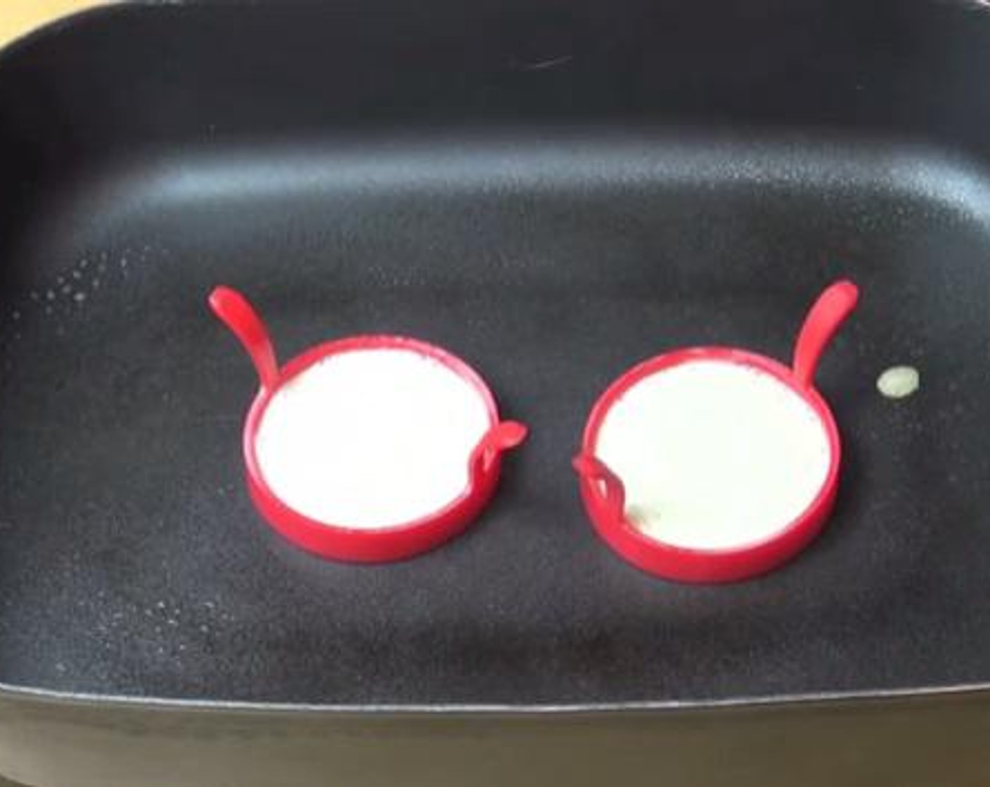 step 4 On a frying pan greased with some oil spray, put egg rings(plastic or metal) and add 2 tablespoons of the dough mixture into each ring. Cook the crumpets on that side for about five minutes.