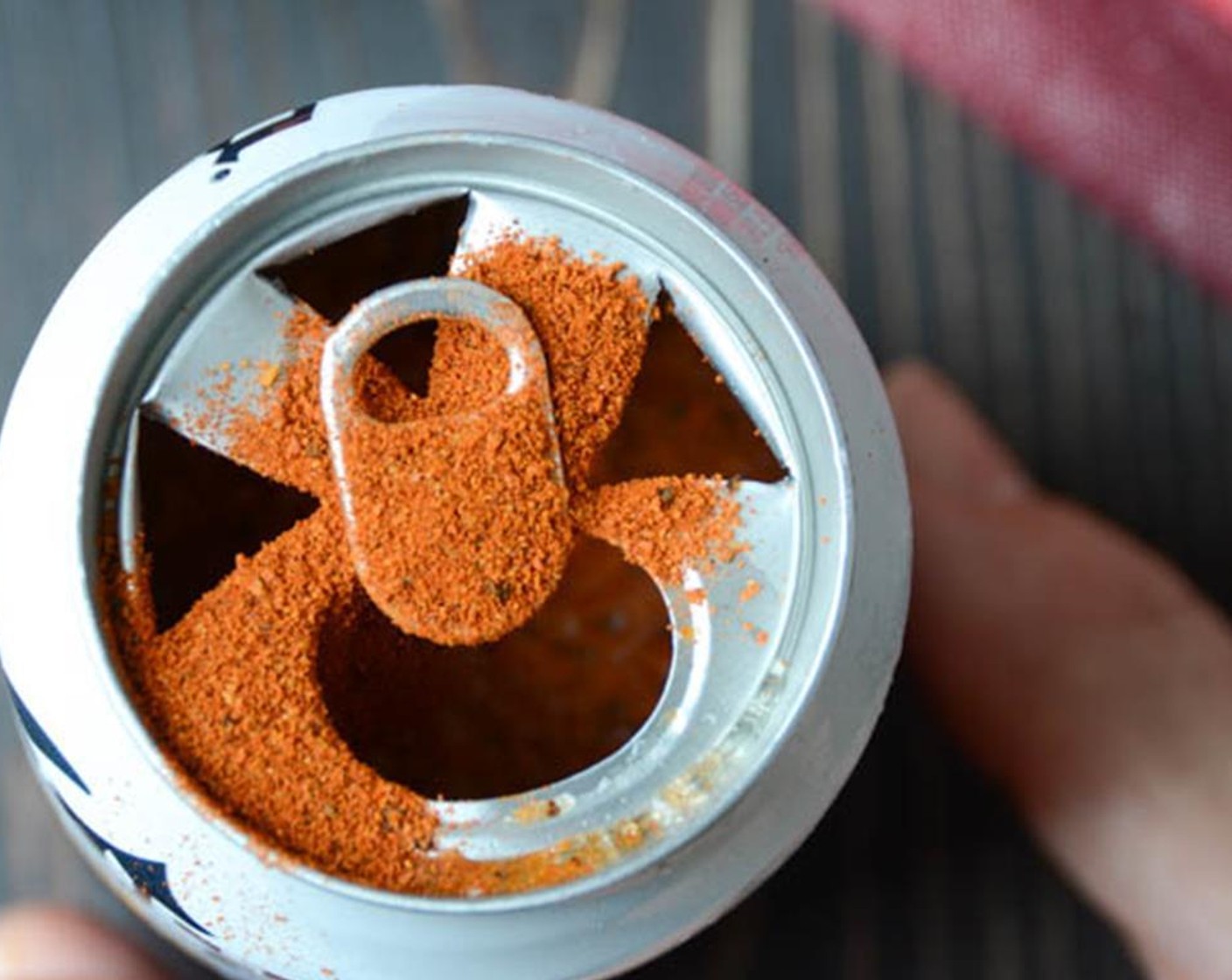 step 7 Use a church key to puncture several holes in the top of the half-empty beer can. Add about a tablespoon of rub to the beer. Carefully insert the beer can into the cavity of the chicken.