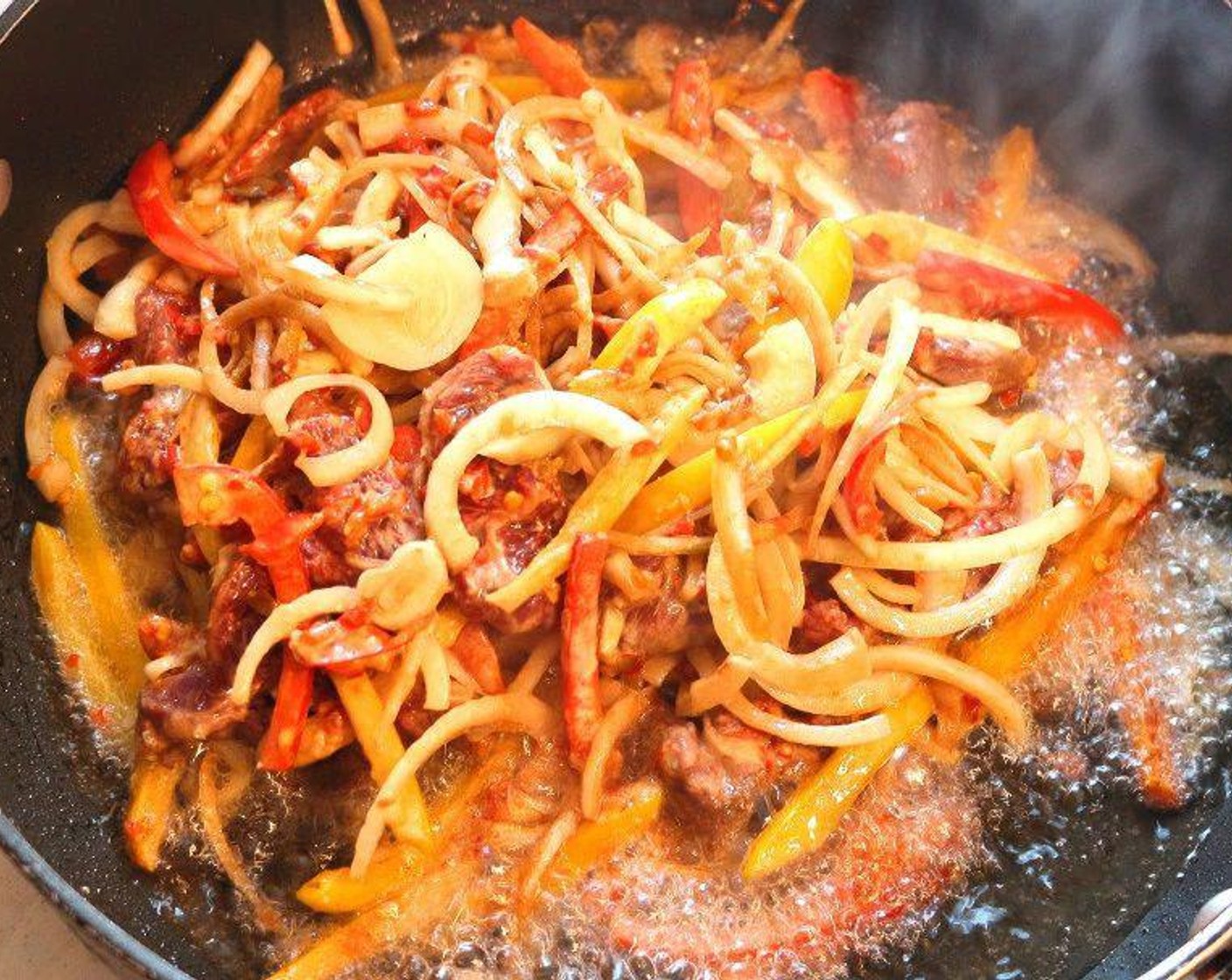 step 4 Heat Peanut Oil (1 cup), saute the beef and veggies at 375 degrees F (190 degrees C) until the onions are golden, remove with a slotted spoon, discard fat.