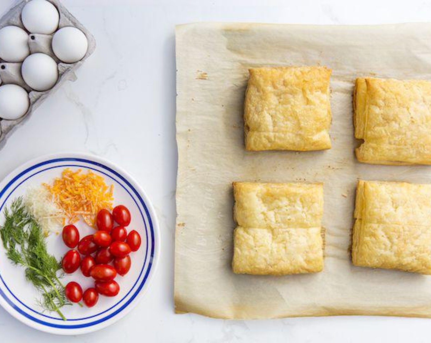 step 3 Let puff pastry squares cool on baking sheet. Using the backside of the fork, deflate the center of the squares. You should leave a small border along the sides, this will prevent the egg from spilling out. Sprinkle evenly with Shredded Cheese (1 1/2 cups).