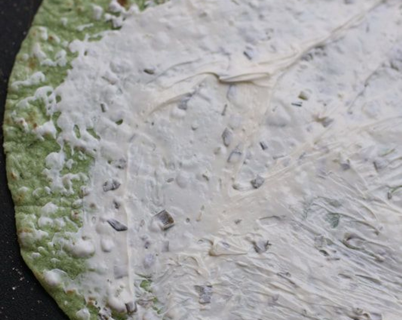 step 1 Smear Onion & Chive Cream Cheese (1 pckg) on top of a Spinach Tortilla Wraps (4).