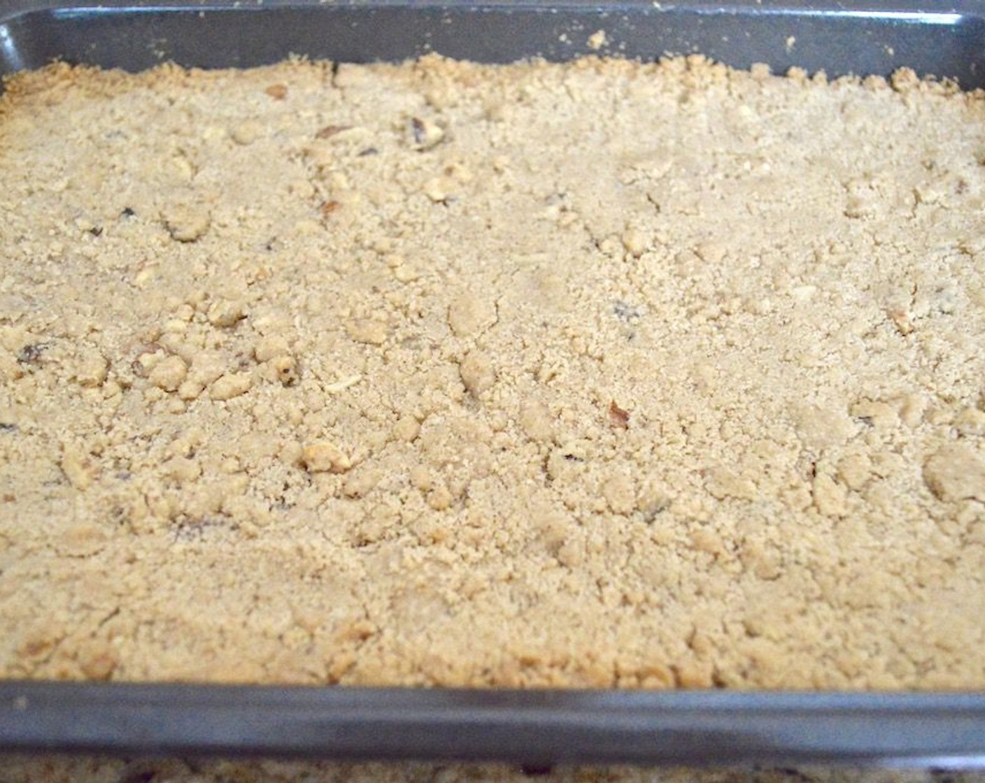 step 10 Reduce the oven heat to 350 degrees F (180 degrees C). Take the crust and spread the filling out evenly on it. Then take the remaining dough and crumble it evenly all over the top. It may not necessarily cover it completely. Bake the bars for about 25 to 30 minutes, until bubbly and completely golden brown on top.