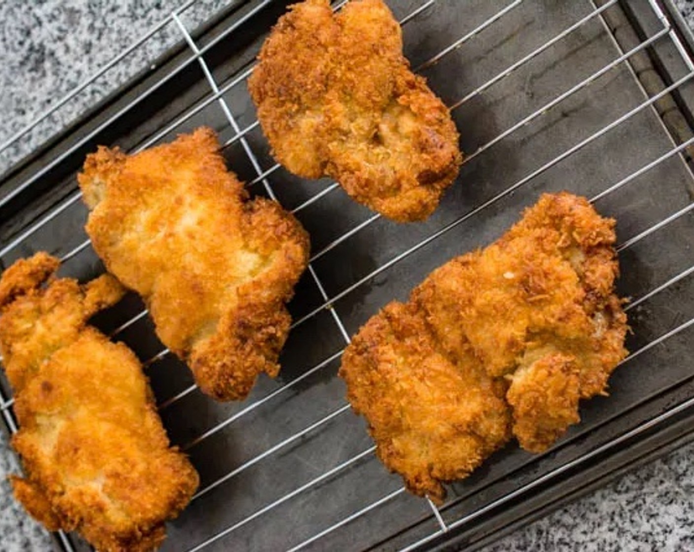 step 7 Place the fried chicken on a cooling rack over a baking sheet, or on oil-absorbing paper.